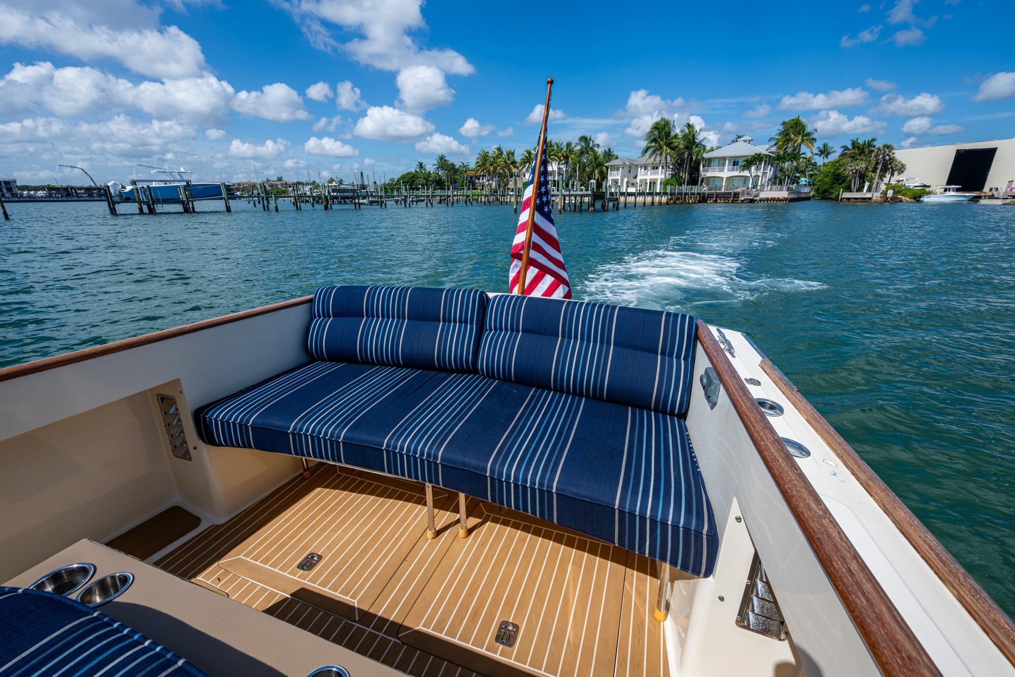 2001 Hinckley Picnic Boat Classic with striped seating, cruising on a sunny day.