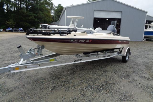 1996 Quantum 180 XD boat on trailer, parked outside a large garage.