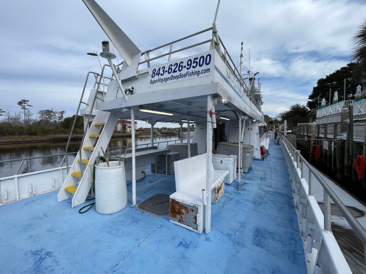 1972 Swiftships commercial passenger boat docked, featuring blue deck and upper seating area.