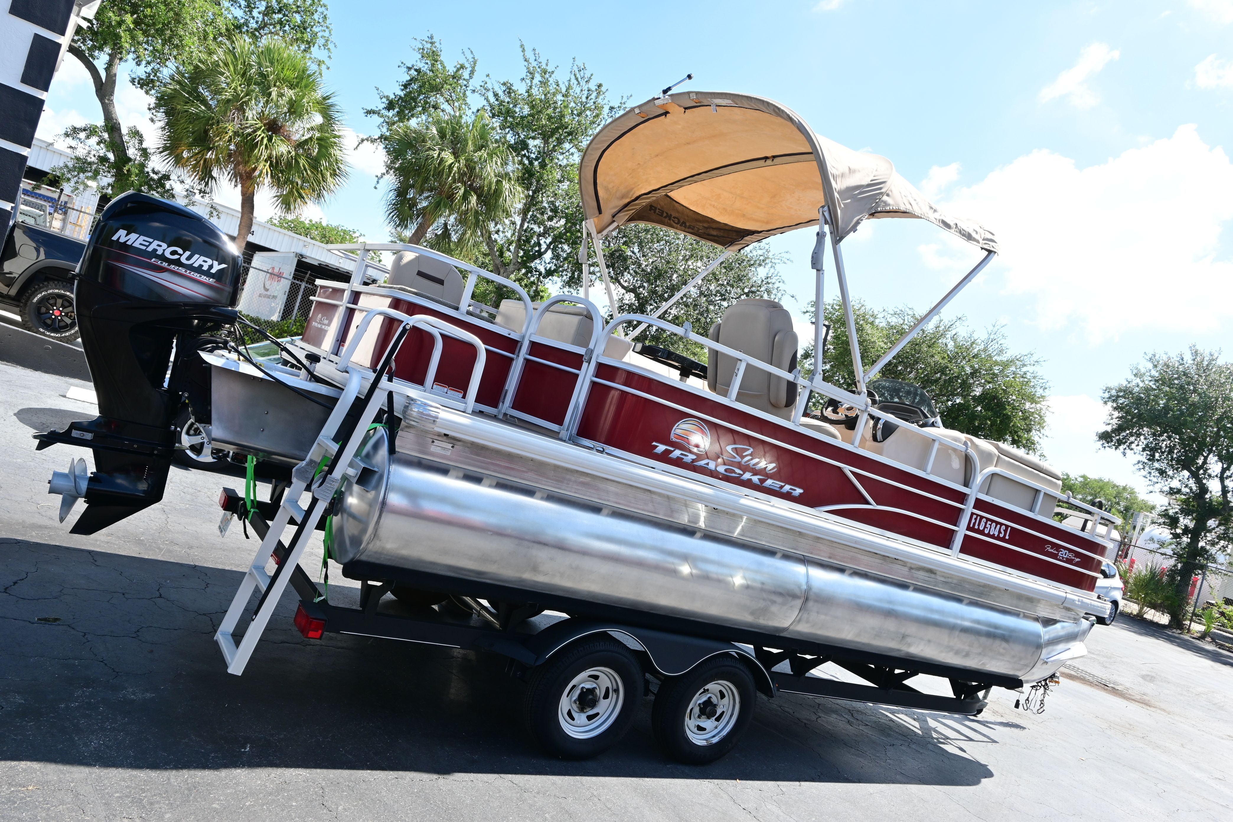 2019 Sun Tracker FISHI pontoon boat with Mercury engine on trailer.
