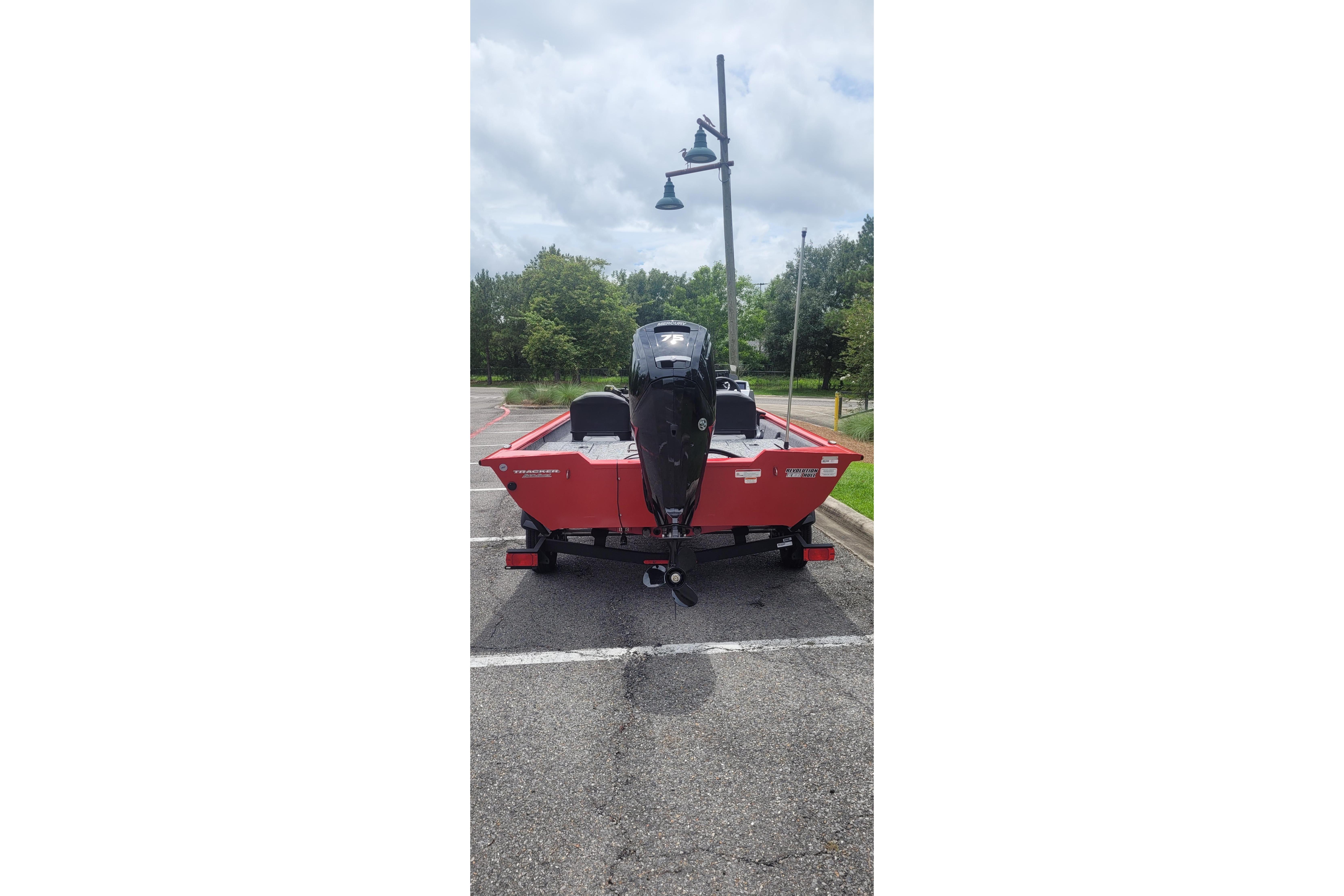 2026 Tracker Pro Team 175 Crappie Edition boat in parking lot, rear view.