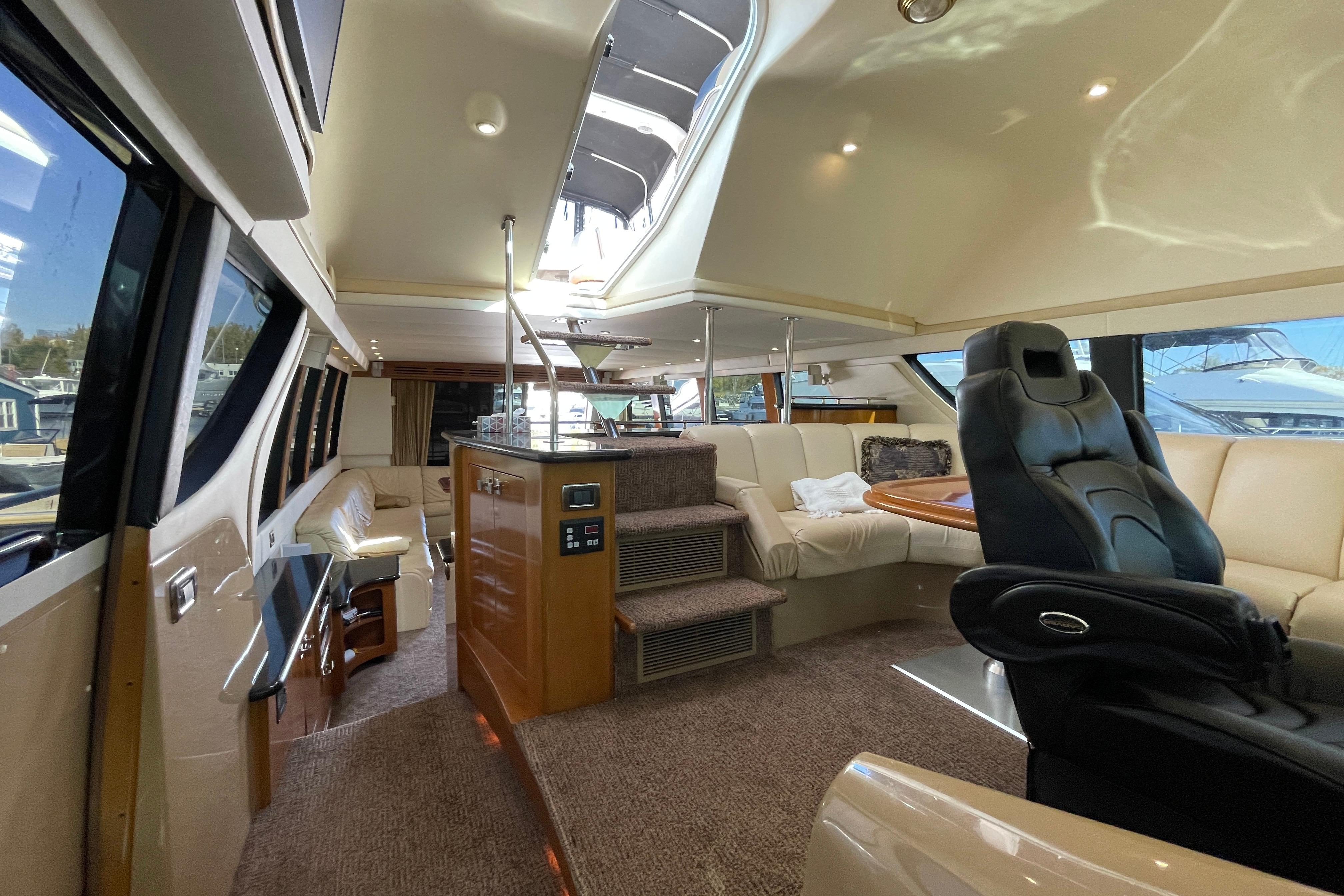 Luxurious interior of 2002 Carver 570 Voyager Pilothouse yacht with plush seating and modern design.