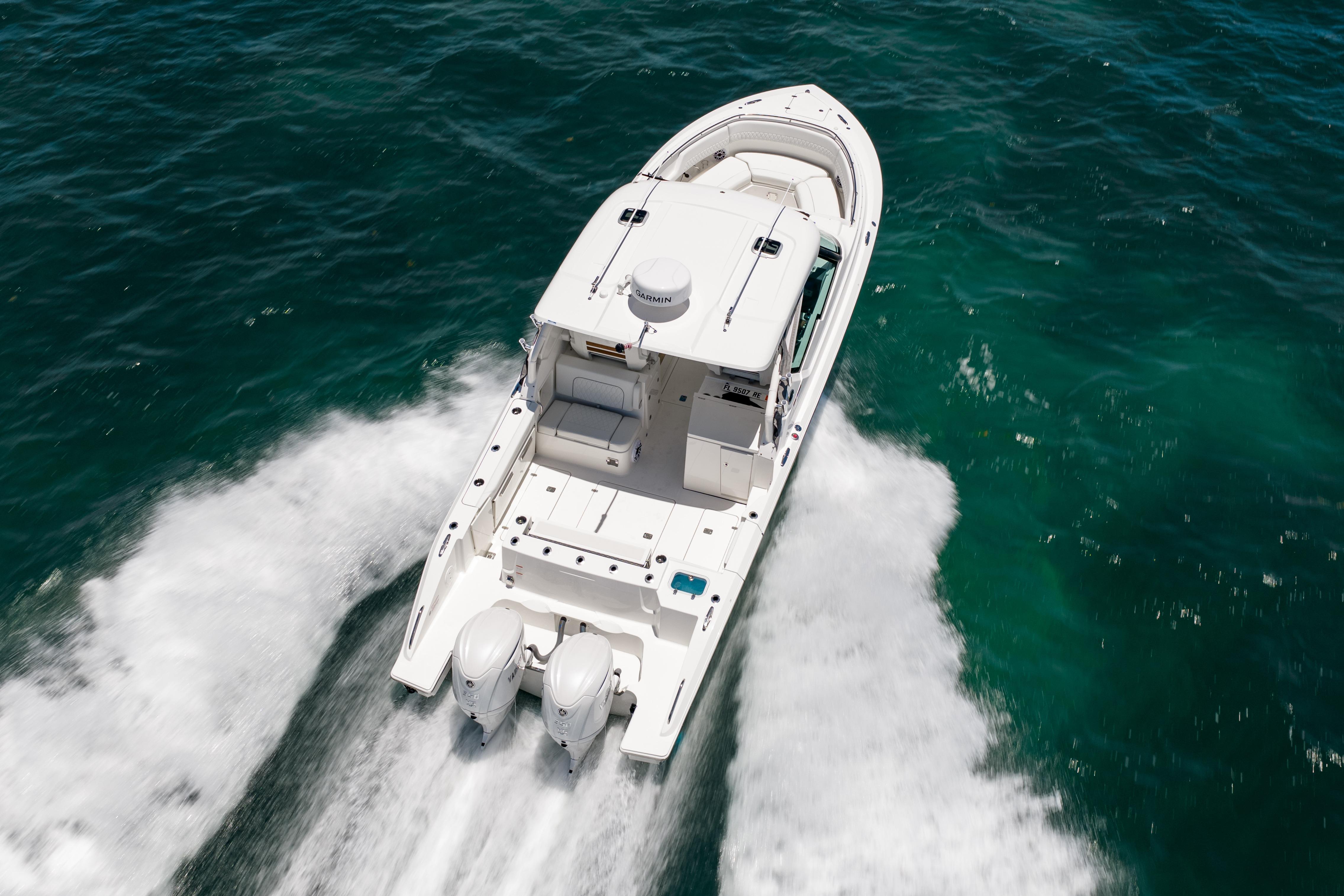2026 Pursuit DC 326 Dual Console boat cruising on open water.