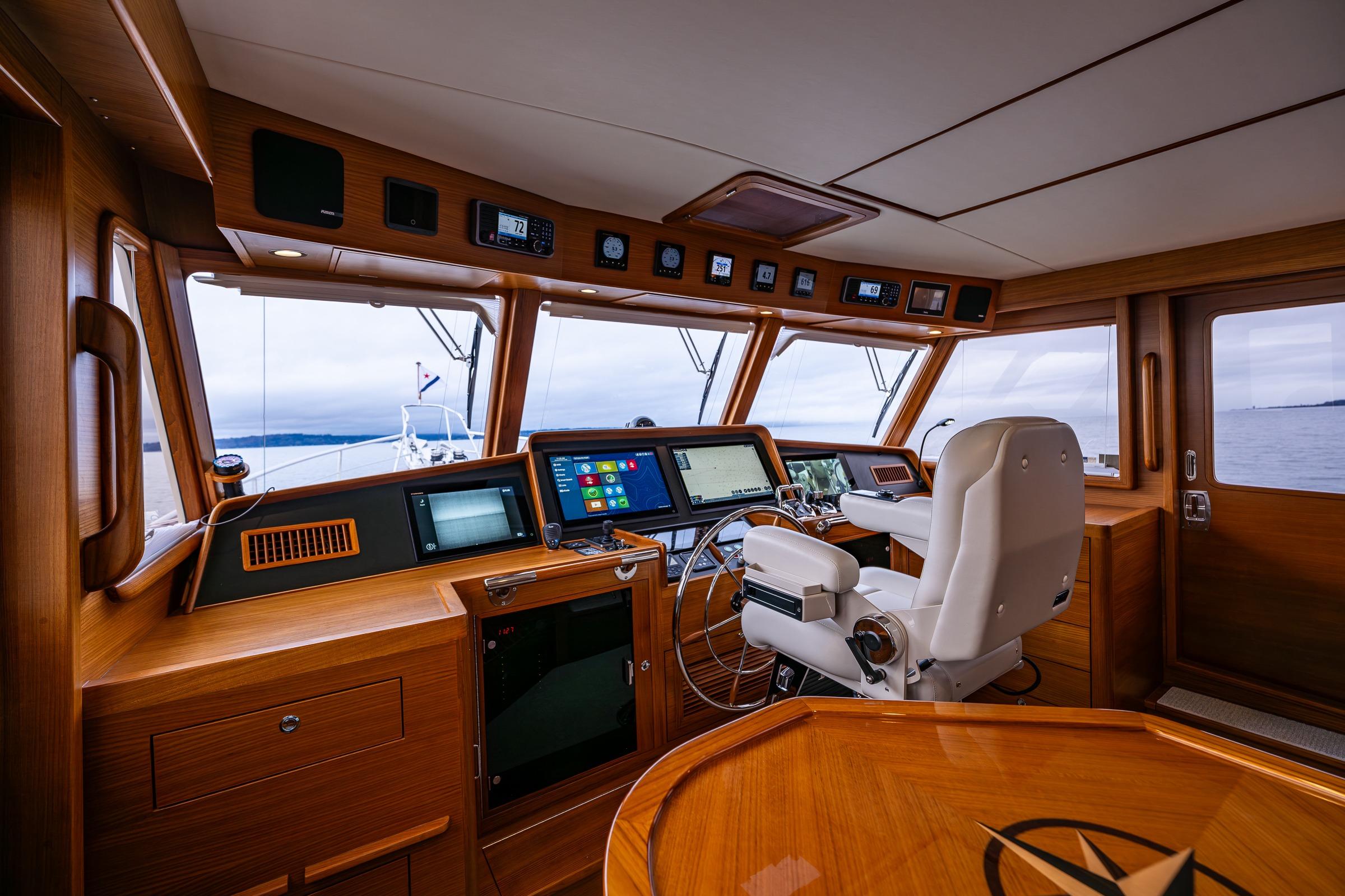 2026 Fleming 55 Pilothouse yacht interior with modern navigation equipment and wooden finish.