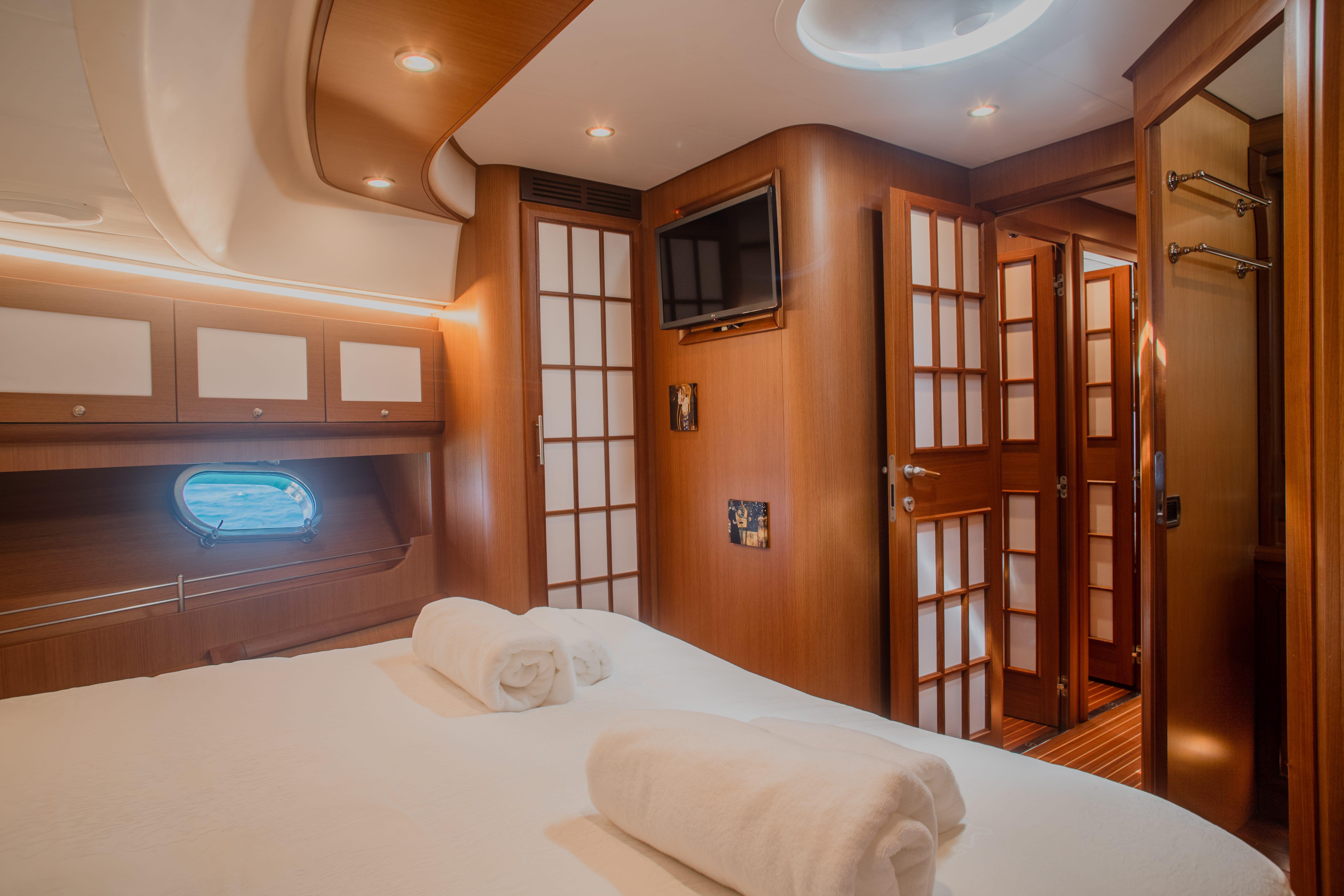 Luxurious cabin interior of 2005 Mochi Craft 74' Dolphin yacht with elegant wood finishes.