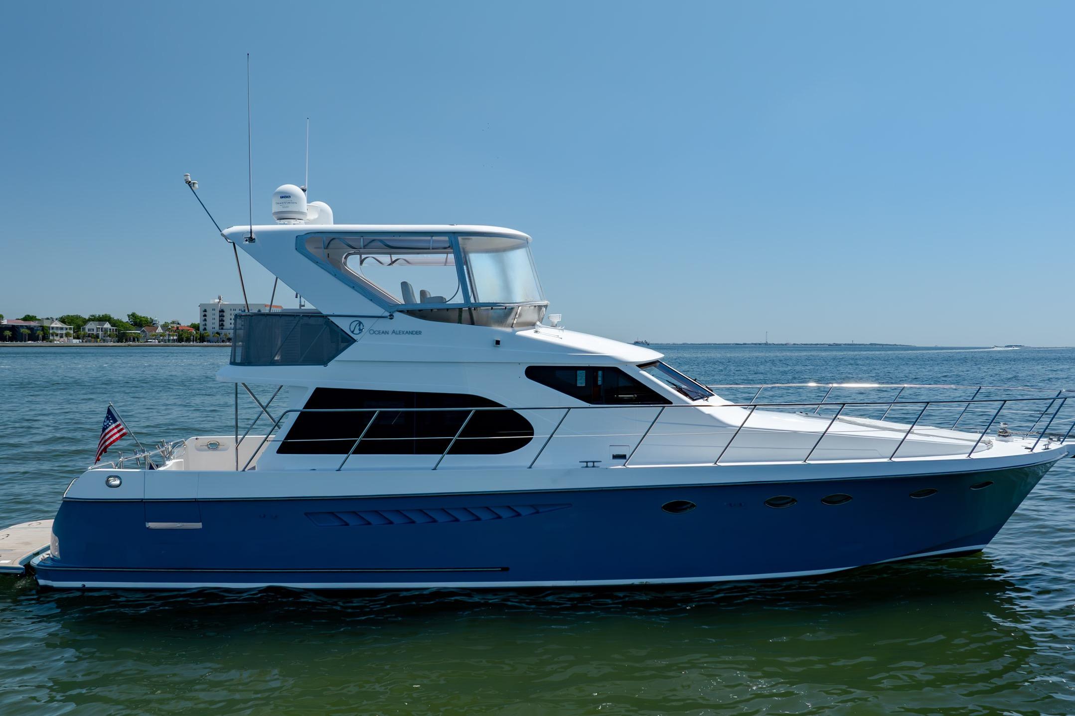 Ocean Alexander yacht on calm waters, featuring sleek design and American flag.