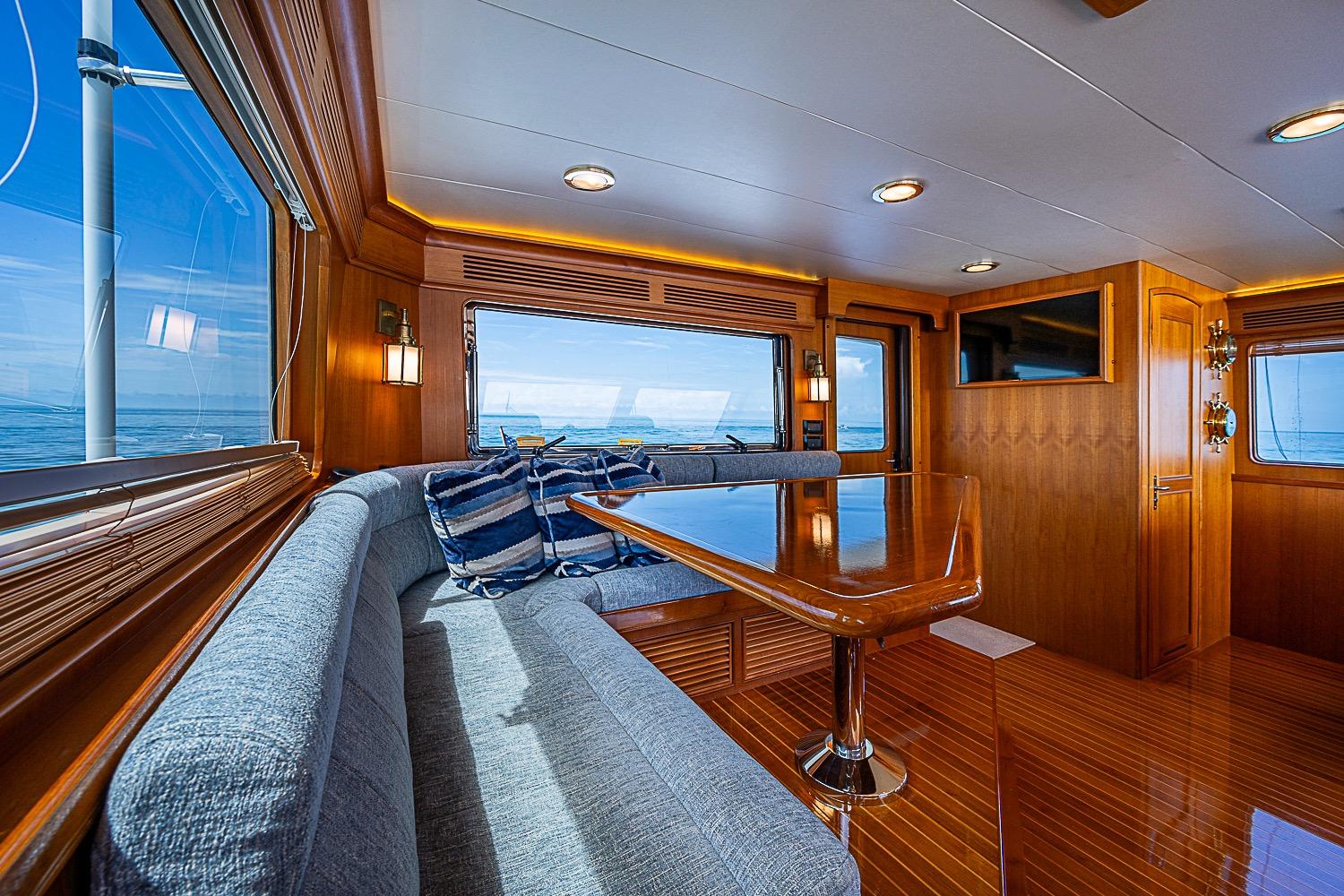 Luxurious interior of 2014 Marlow 80 Explorer yacht with elegant wood finishes and ocean views.