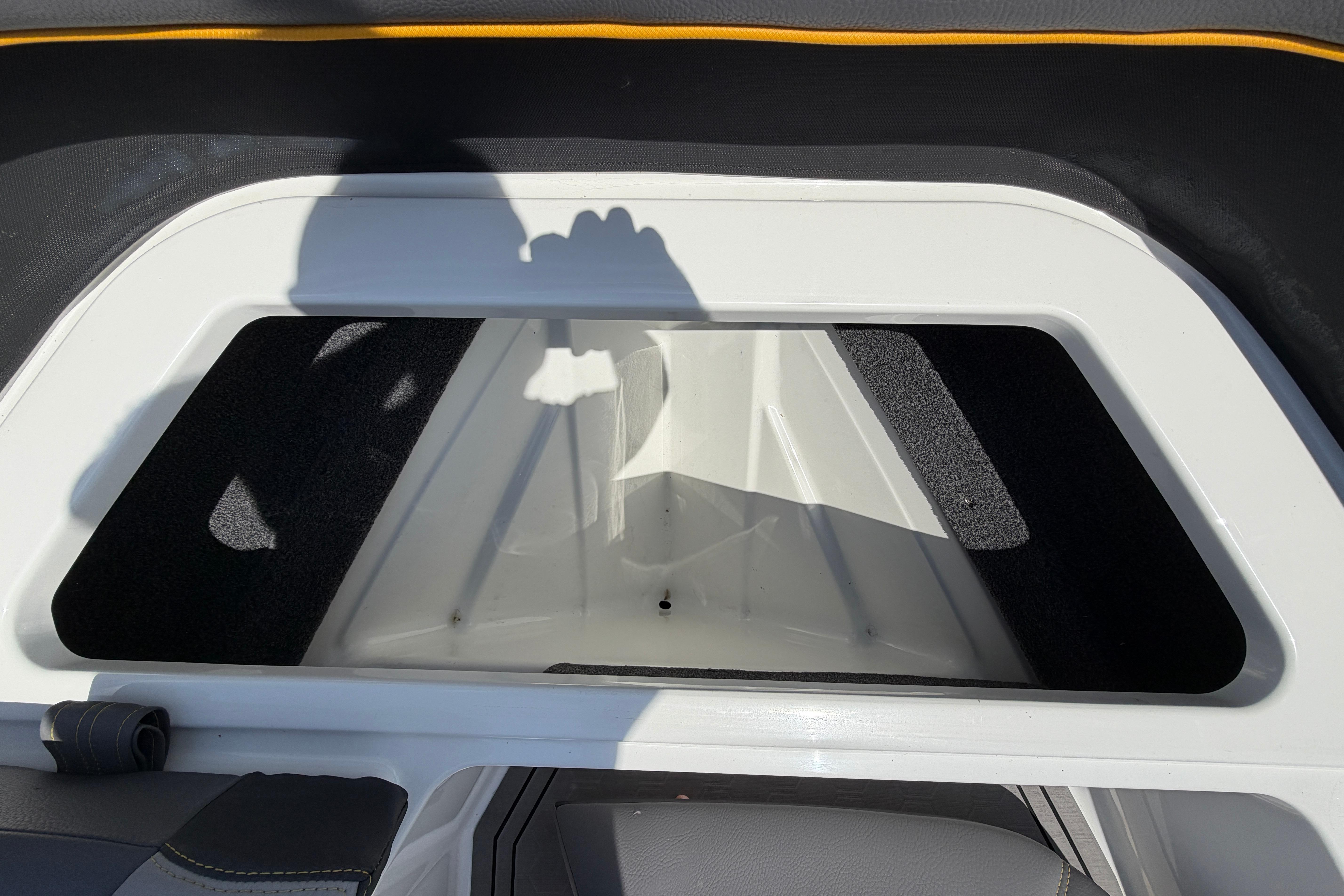 Storage compartment inside a 2021 Cobalt R8 Surf boat.