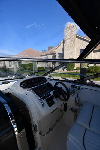 1997 Sunseeker Camargue 47 yacht cockpit with steering wheel, dashboard, and seating.