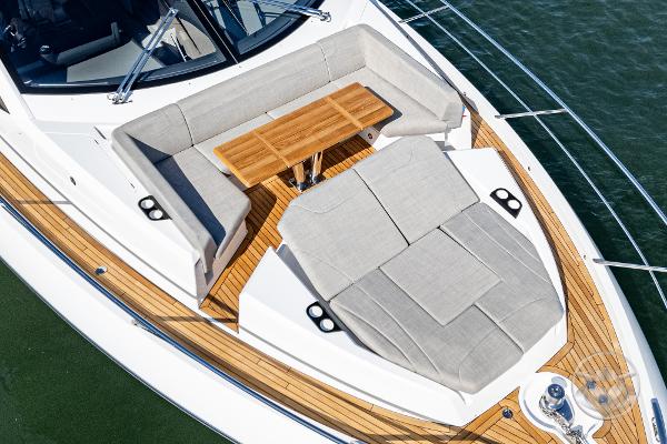 Luxurious Sunseeker Manhattan 68 yacht deck with elegant seating and wooden table, 2025 model.