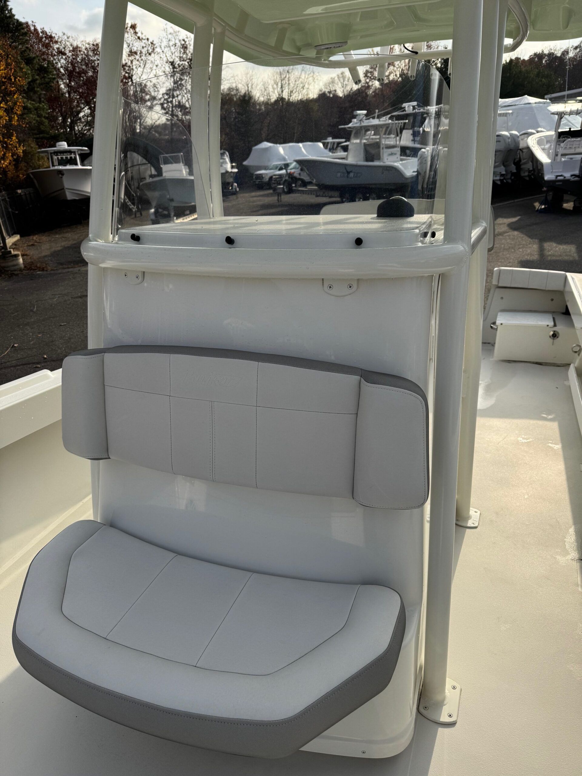 Sportsman Open 232 Center Console 2023 with gray seating and helm station outdoors.