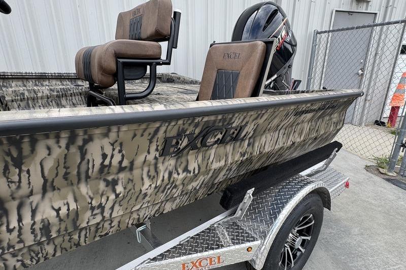 2027 Excel 230 Bay Pro Elite boat on trailer, featuring camo design and comfortable seating.
