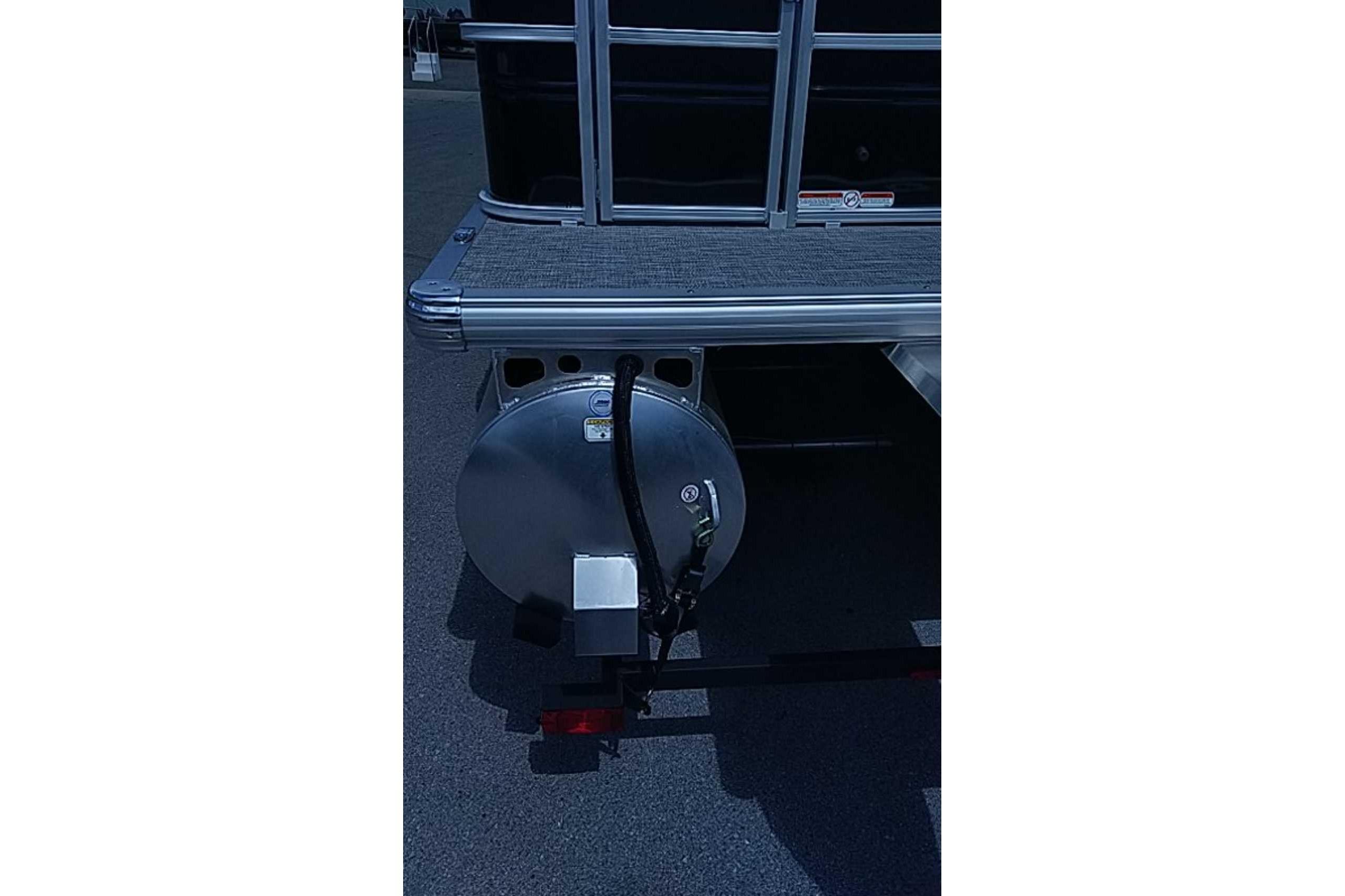 Rear view of 2026 Sun Tracker SportFish 22 DLX pontoon boat on trailer.