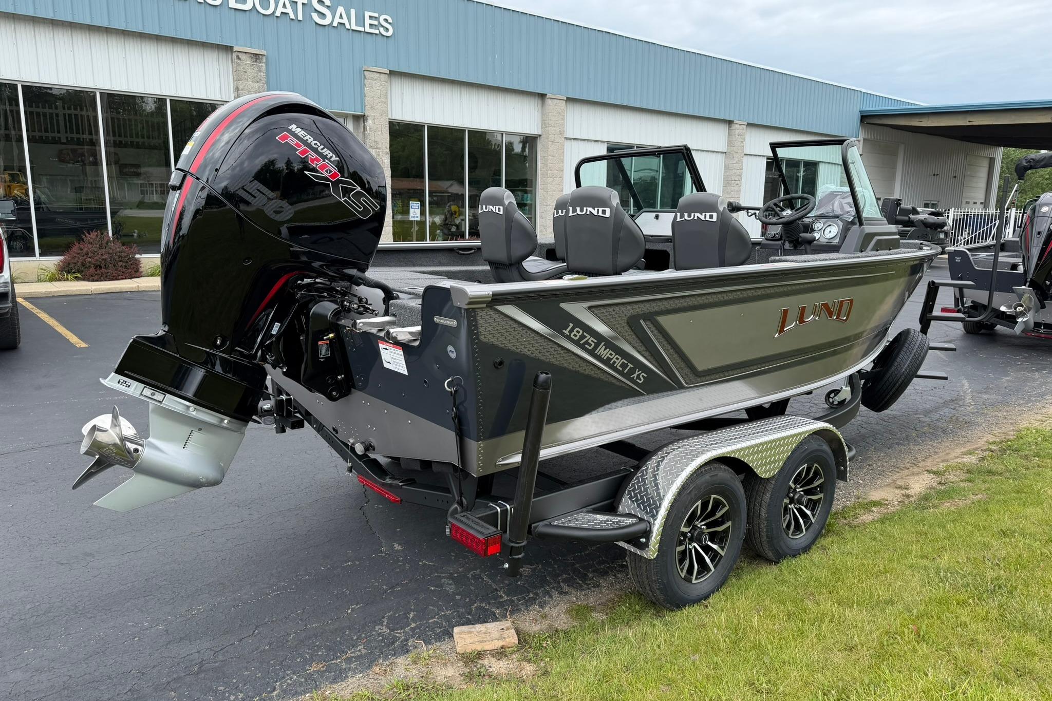 2027 Lund 1875 Impact XS Sport boat with Mercury engine on trailer.