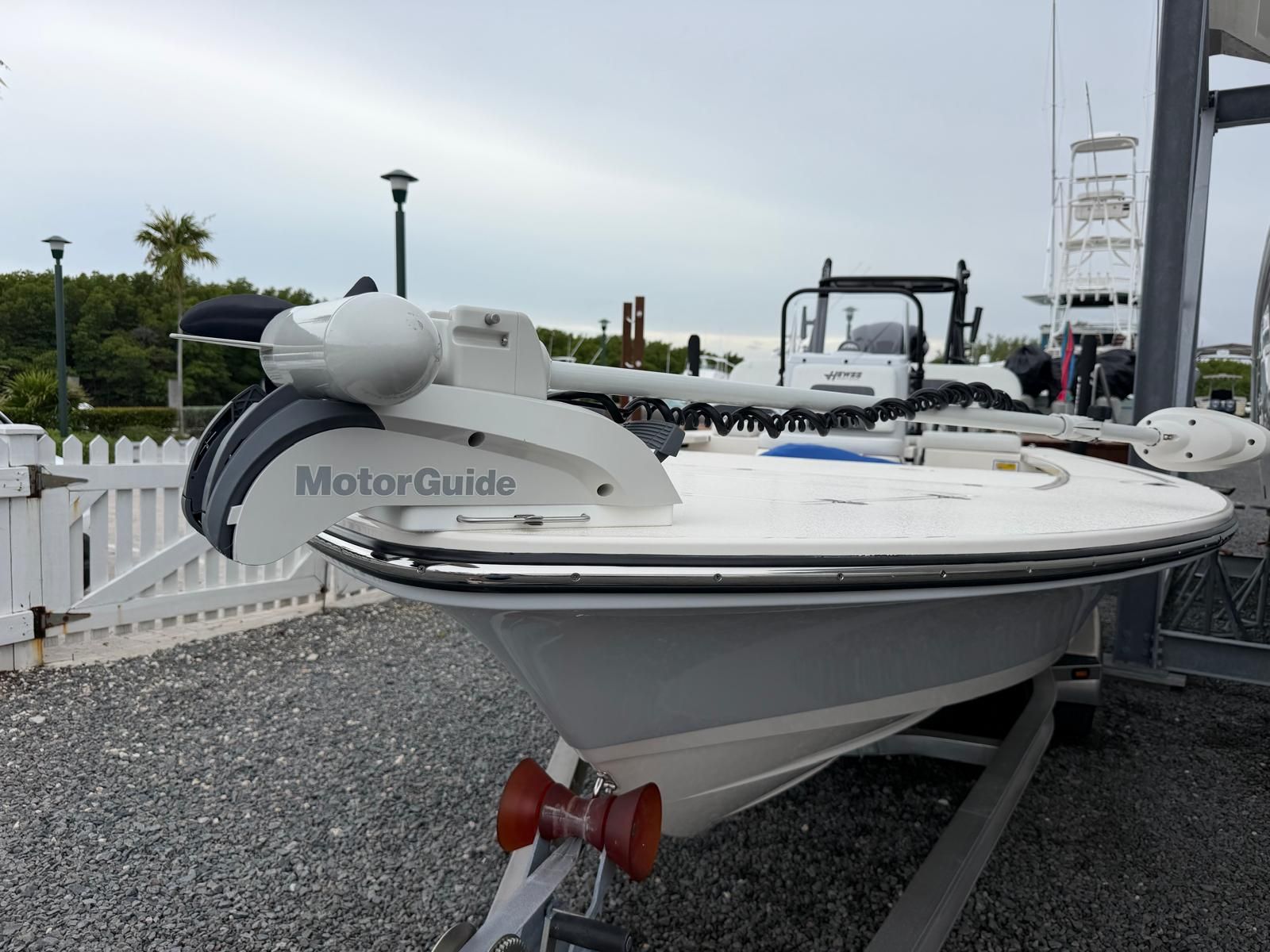 A 2022 Hewes Redfisher 21 boat on a trailer, featuring a MotorGuide motor.
