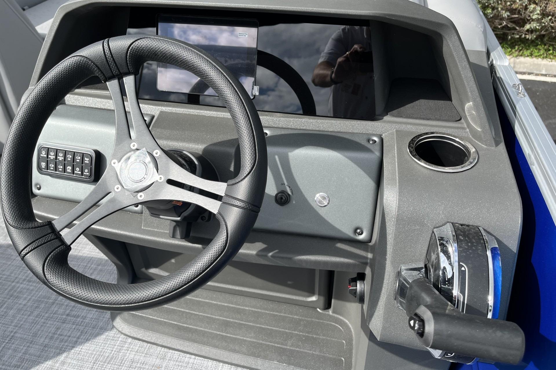 Steering console of 2026 Sun Tracker Party Barge 20 DLX with modern controls.