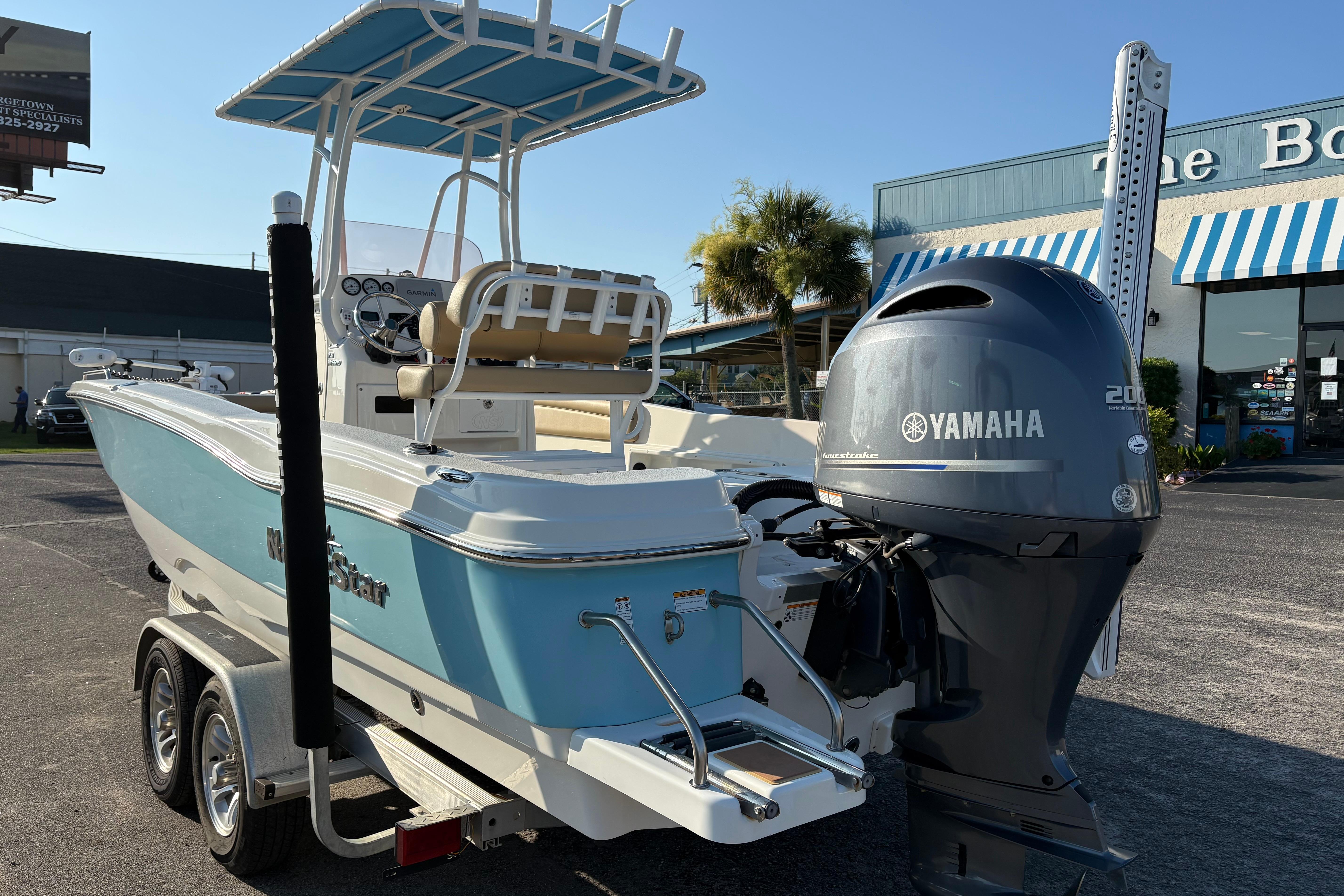 2019 NauticStar 231 Hybrid boat with Yamaha engine, parked on a trailer.