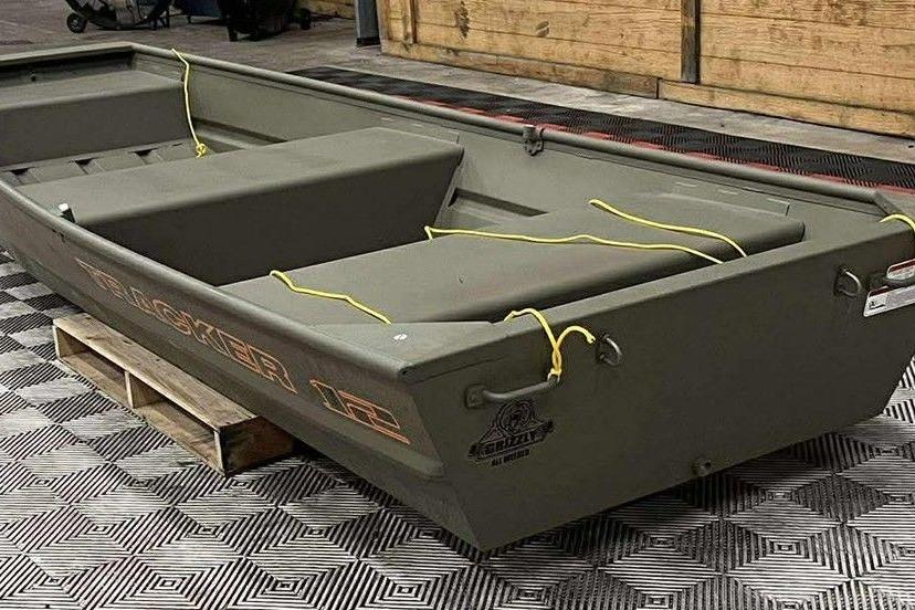 2026 Tracker Grizzly 12 Jon boat on display, featuring durable design and seating.