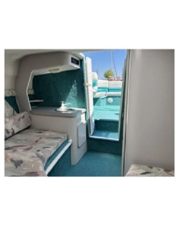 Interior of a 1993 Chris-Craft 238 Cuddy Concept with seating area and deck access.
