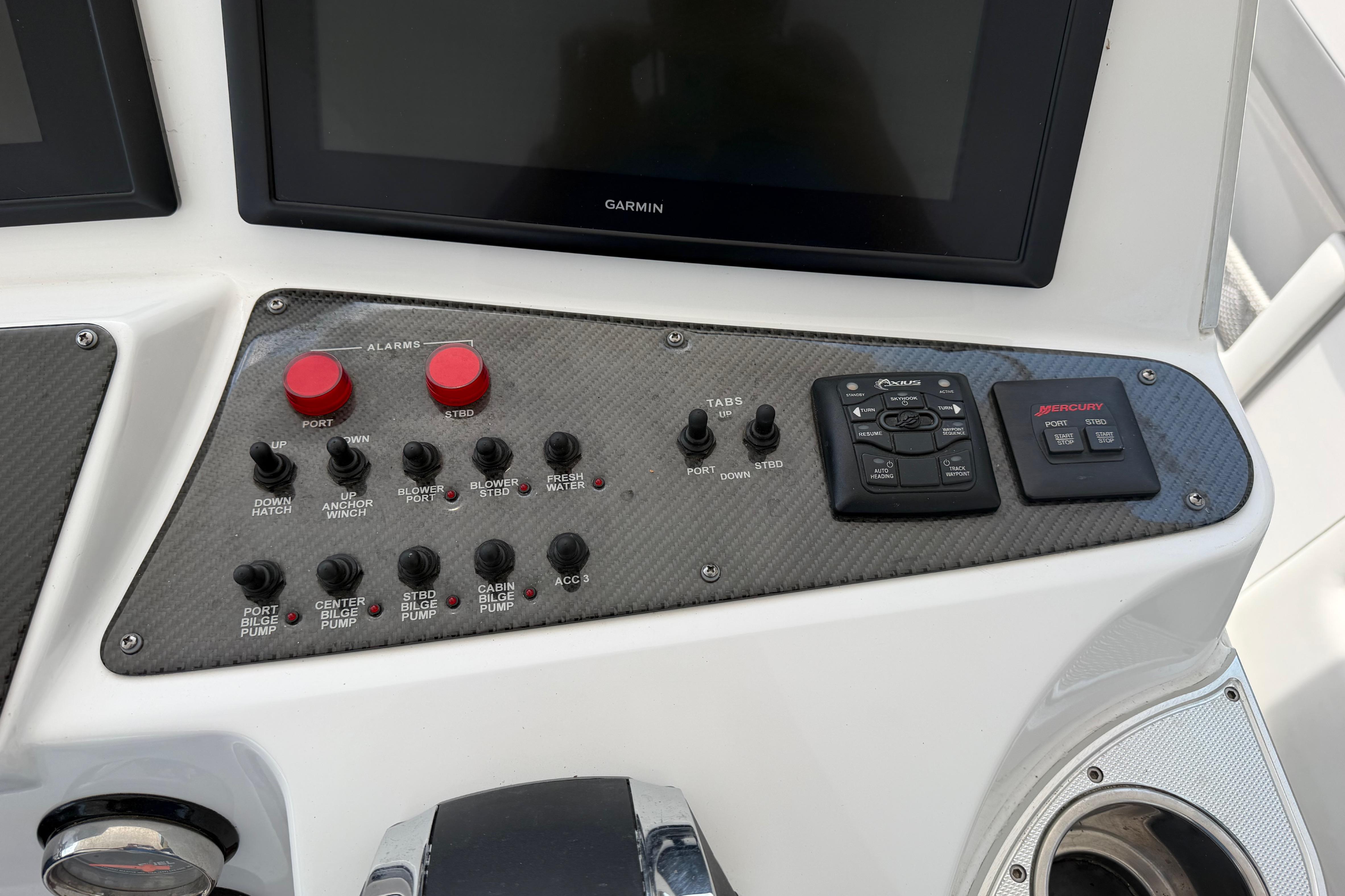 Control panel of 2015 Cigarette 41' Nighthawk SD Edition boat with various switches and displays.