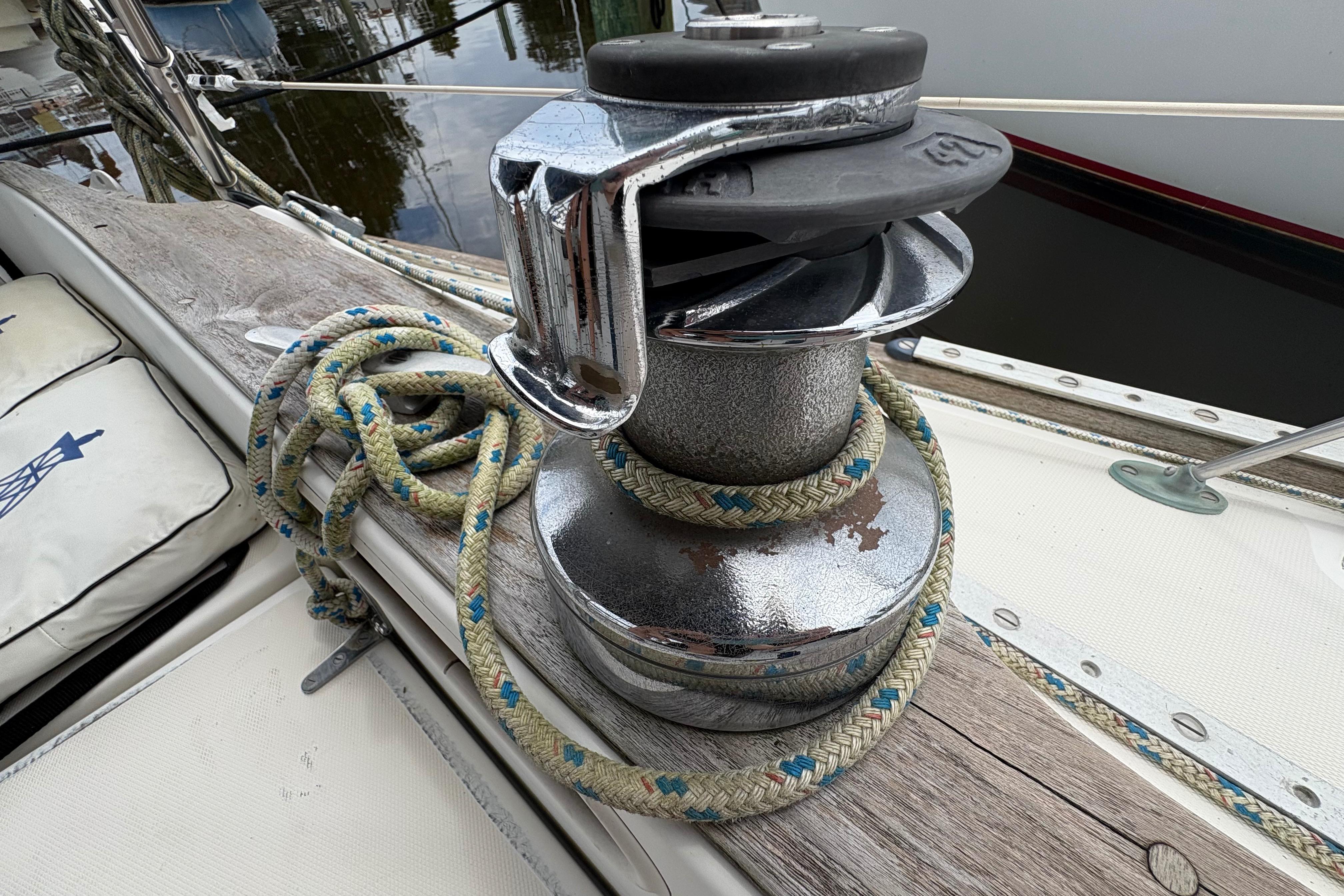 Winch and rope on 1981 Sabre 31 sailboat deck, close-up view.