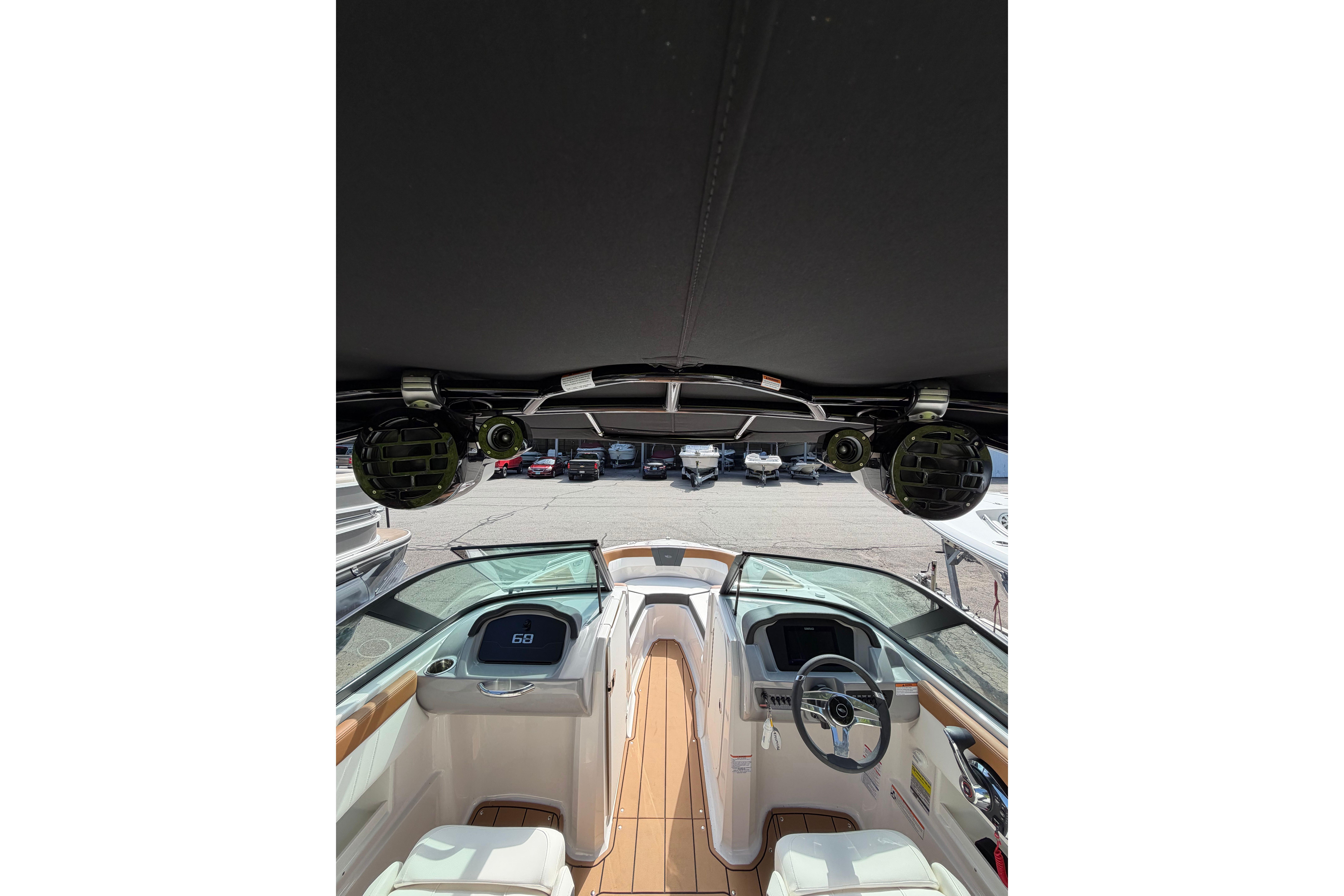 Interior view of 2025 Chaparral 230 SSi boat, showcasing helm and seating area.
