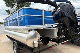 2026 Sun Tracker Party Barge 18 DLX pontoon boat with Mercury outboard motor.