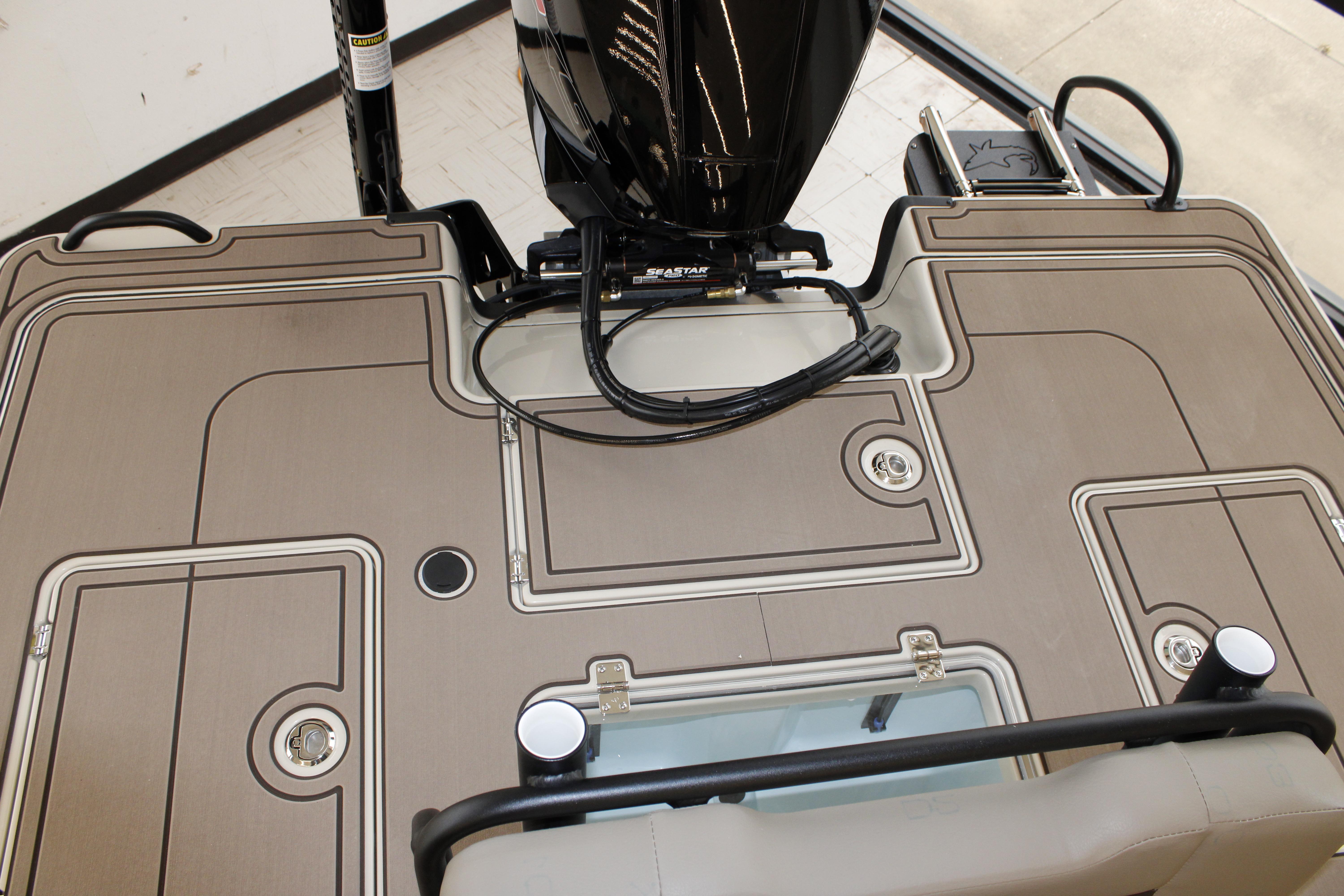 2026 Mako 18 Pro Skiff Backwater Edition boat deck with motor and storage compartments.