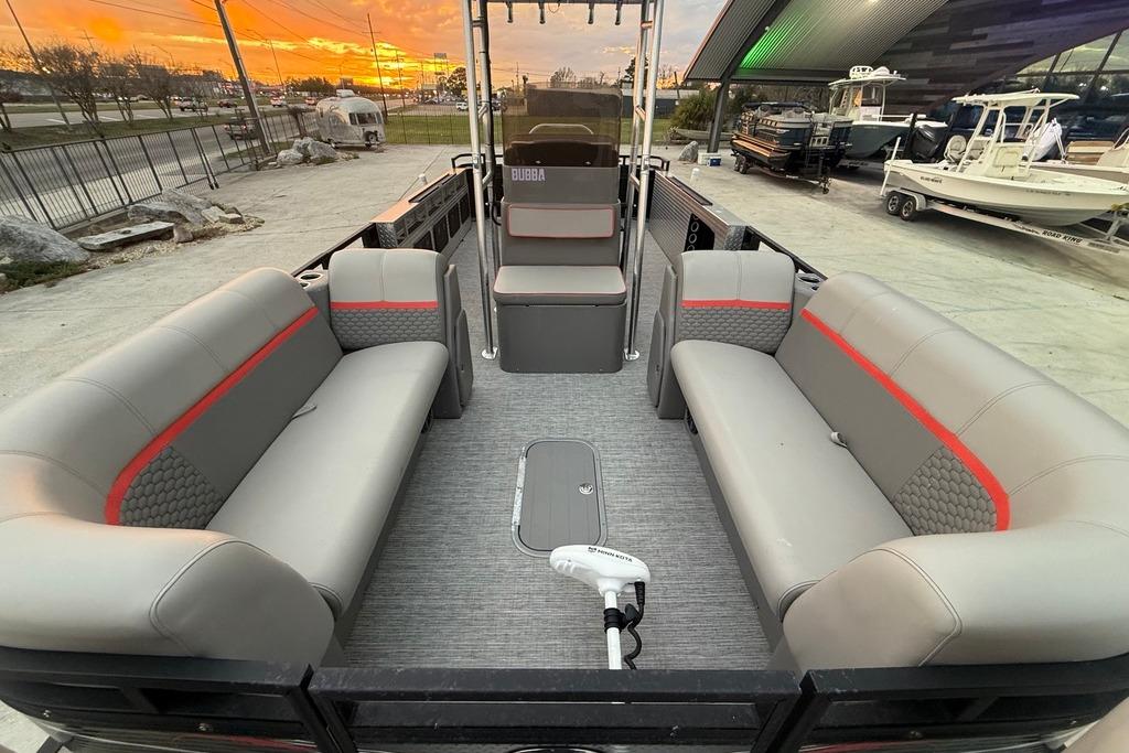 2022 Apex Marine 8524 Pro Fish N Cruise pontoon boat interior with gray seating and red accents.