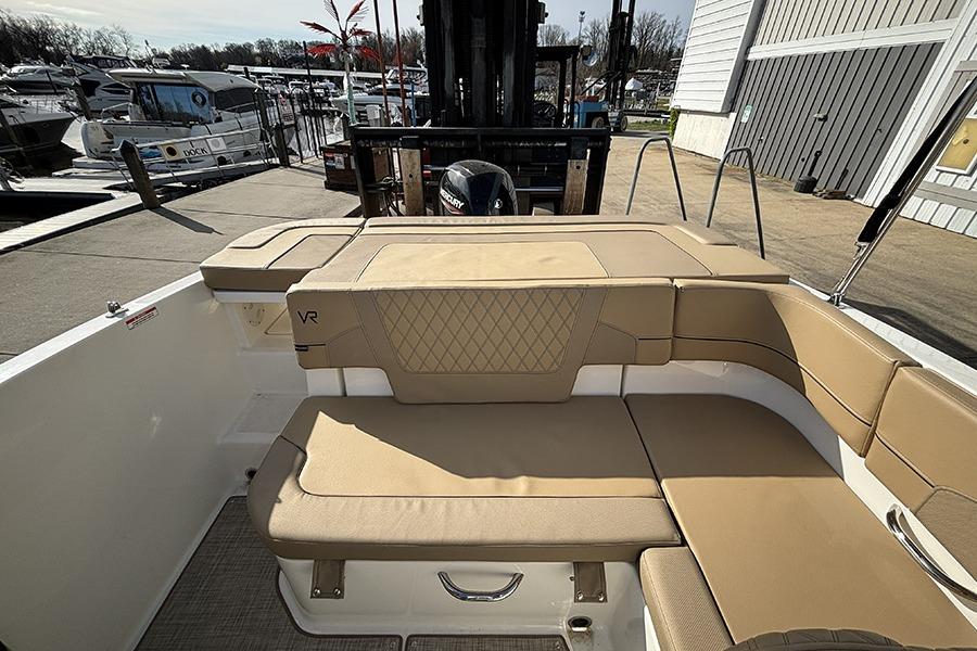 2023 Bayliner VR5 Bowrider OB interior with tan seating at a marina.