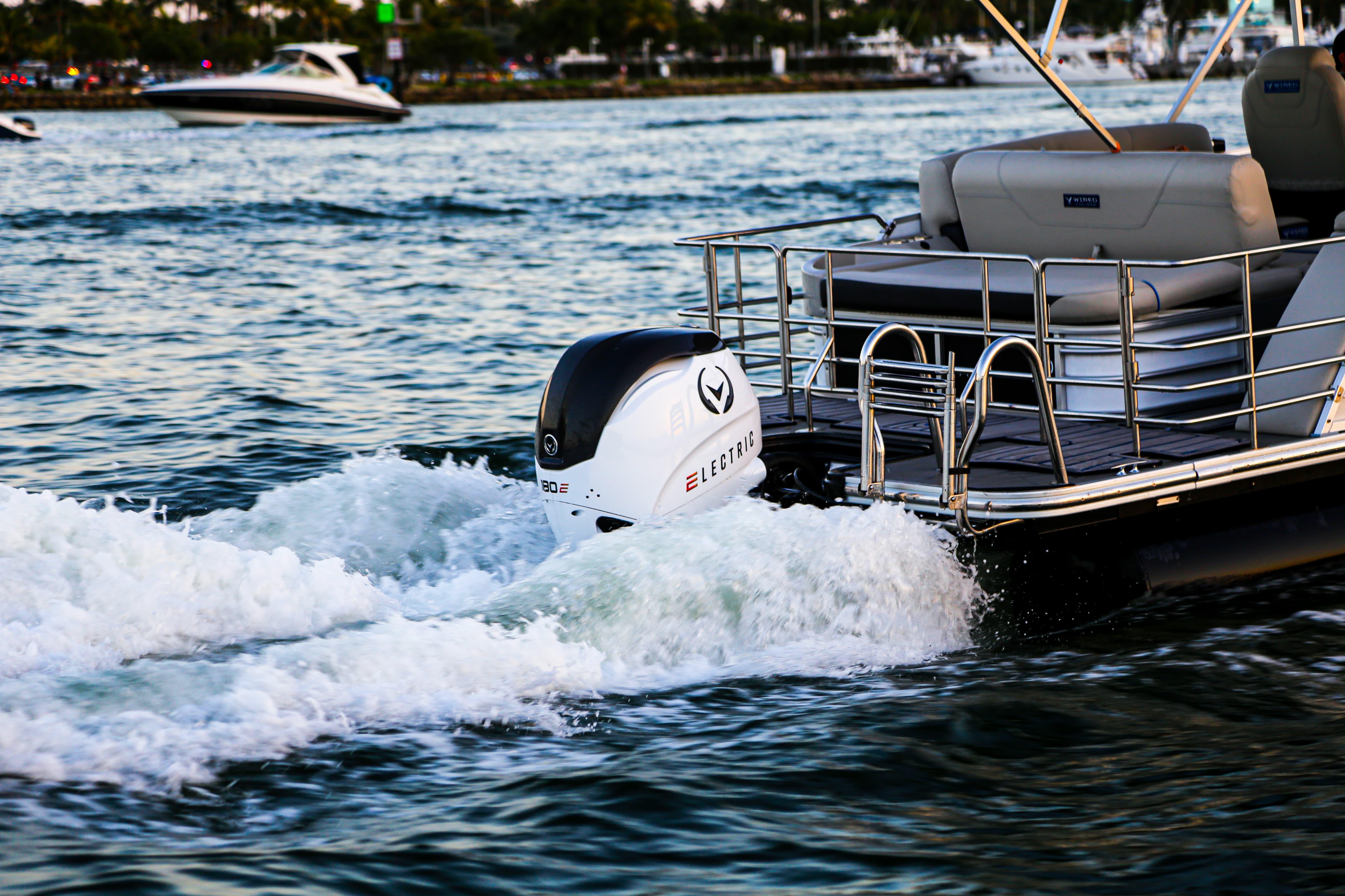Electric Vision Marine Technologies V24 boat cruising on water, showcasing modern design, 2025 model.