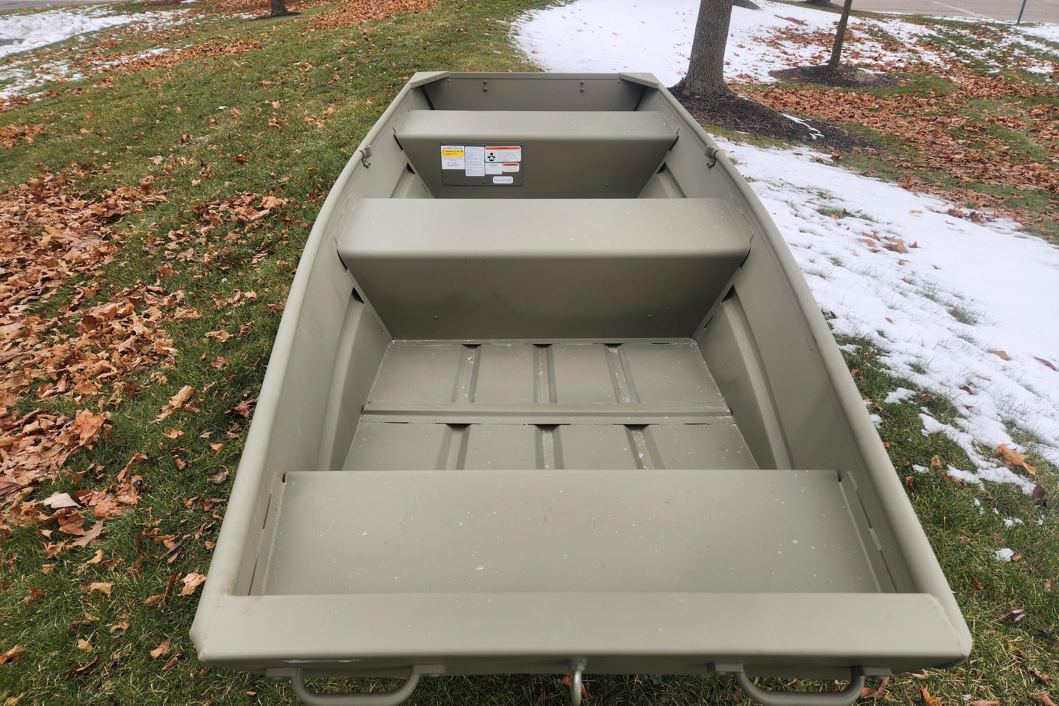2026 Tracker Grizzly 12 Jon boat on grass with autumn leaves and snow.