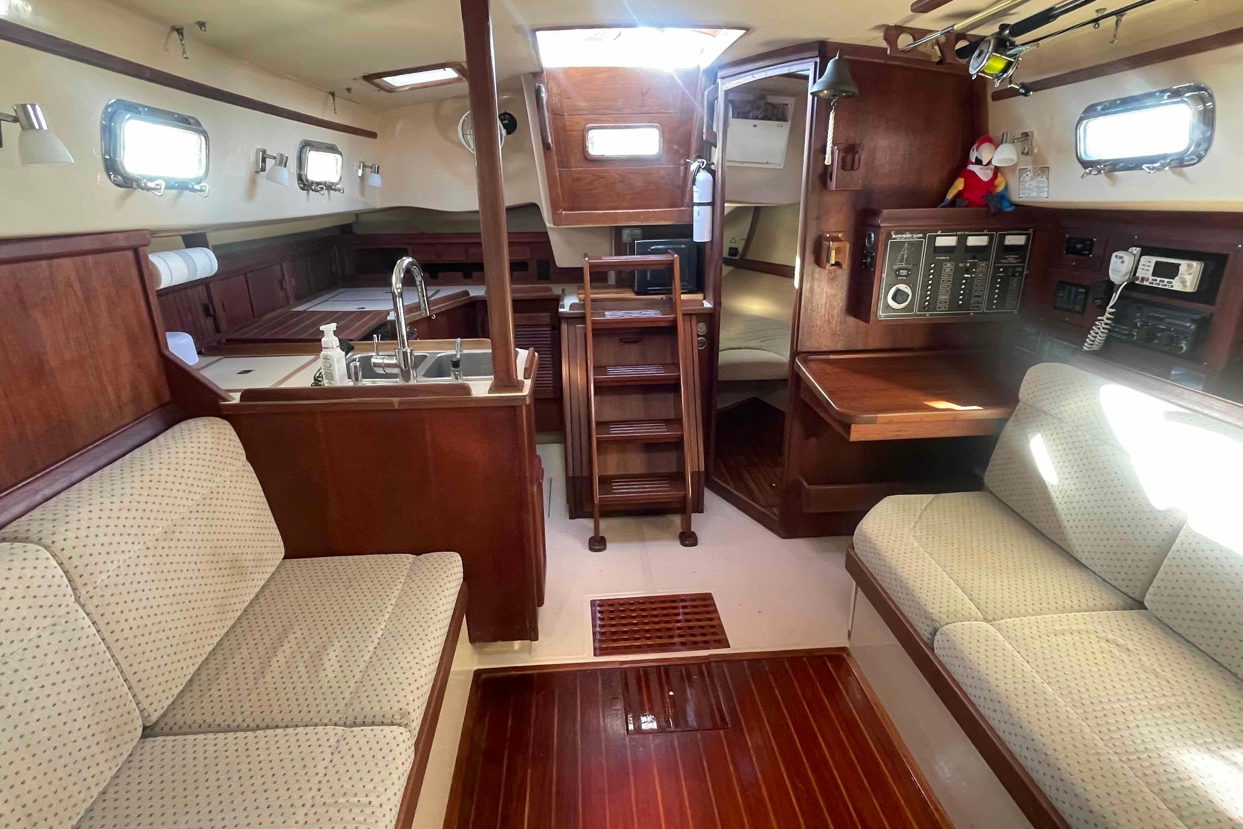 Interior of 1989 Island Packet 35 sailboat with wood finish and seating area.