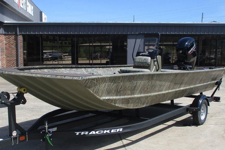 2026 Tracker Grizzly 2072 CC boat on trailer, camo design, parked outdoors.
