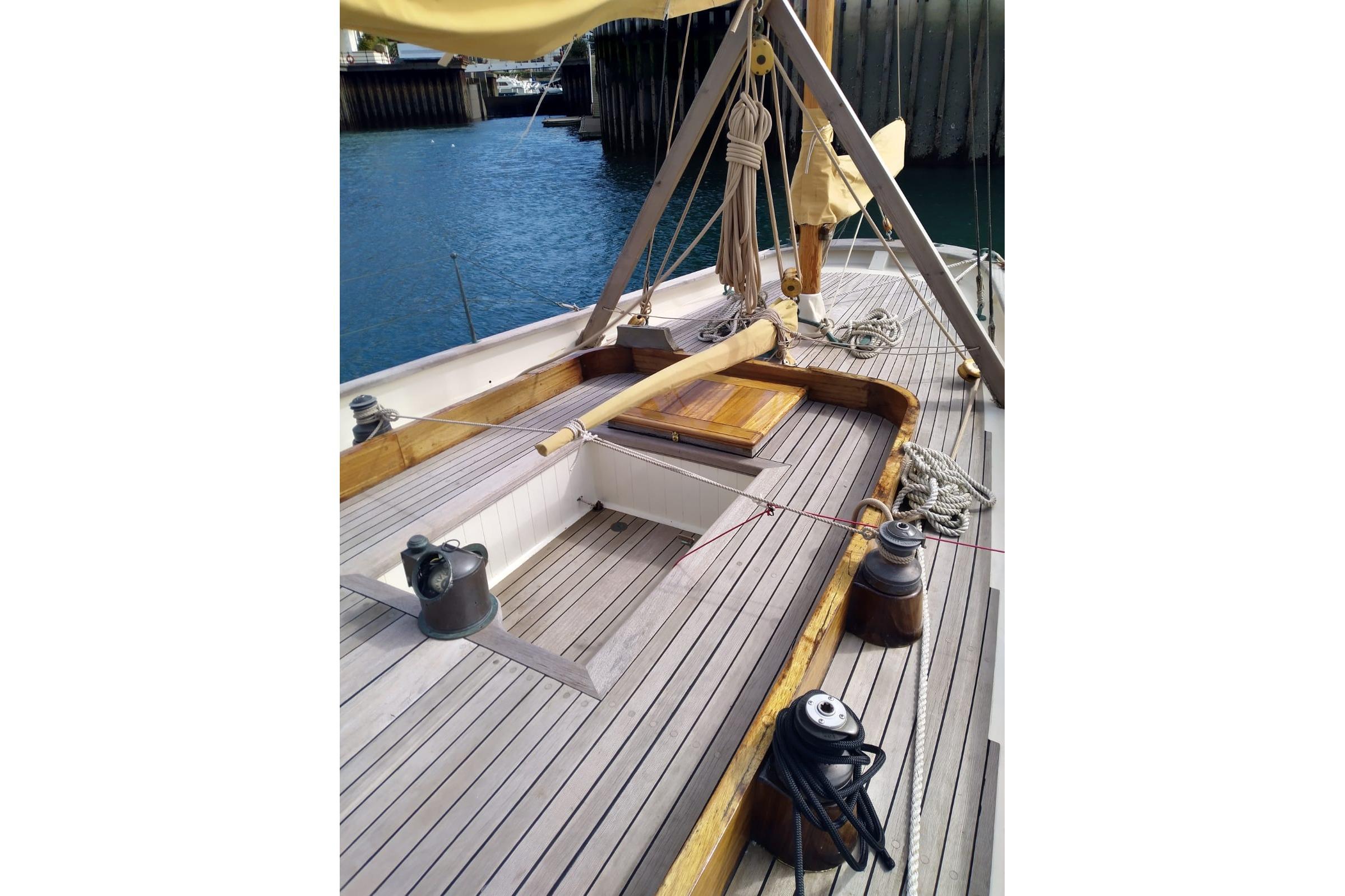 Deck of 2012 Custom Mayflower 50 sailboat with wooden finish and nautical equipment.