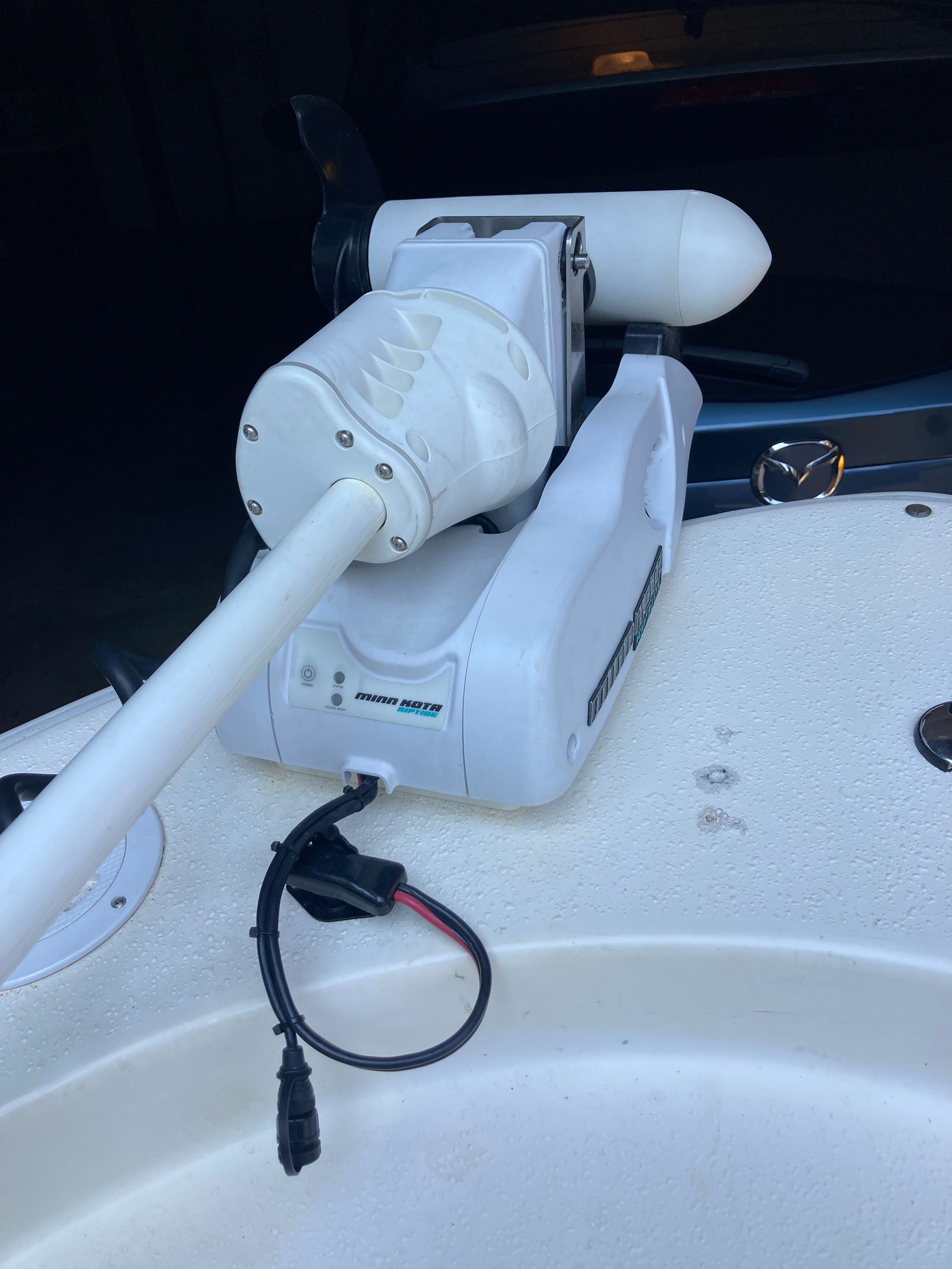 Close-up of a white boat motor on a 2012 Carolina Skiff JVX16CC.