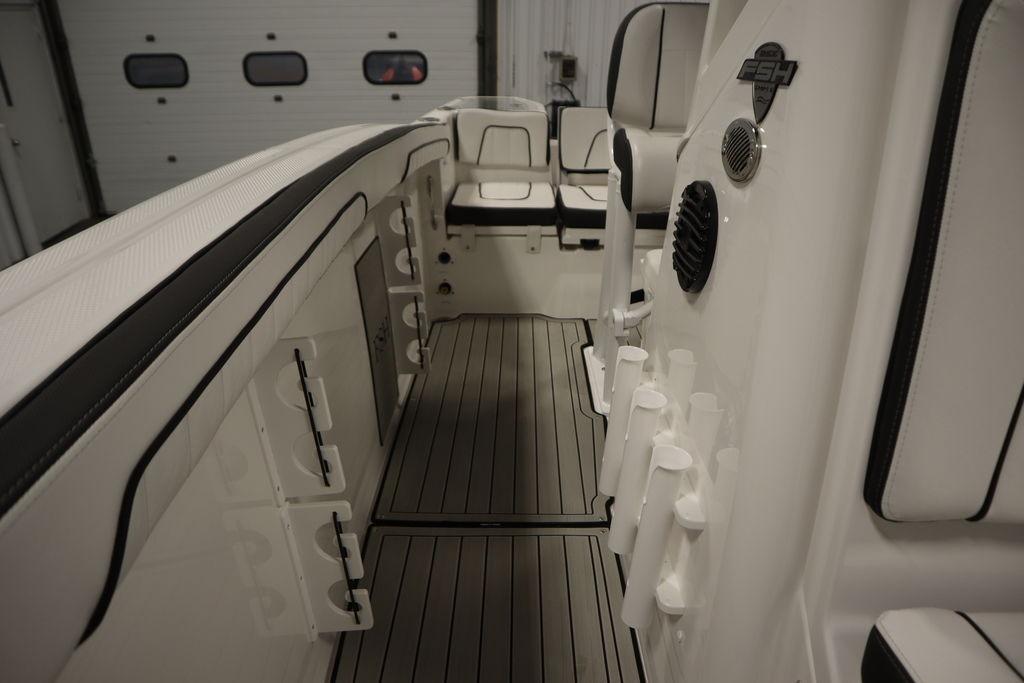 2026 Yamaha Boats 255 FSH Sport E interior with rod holders and seating.