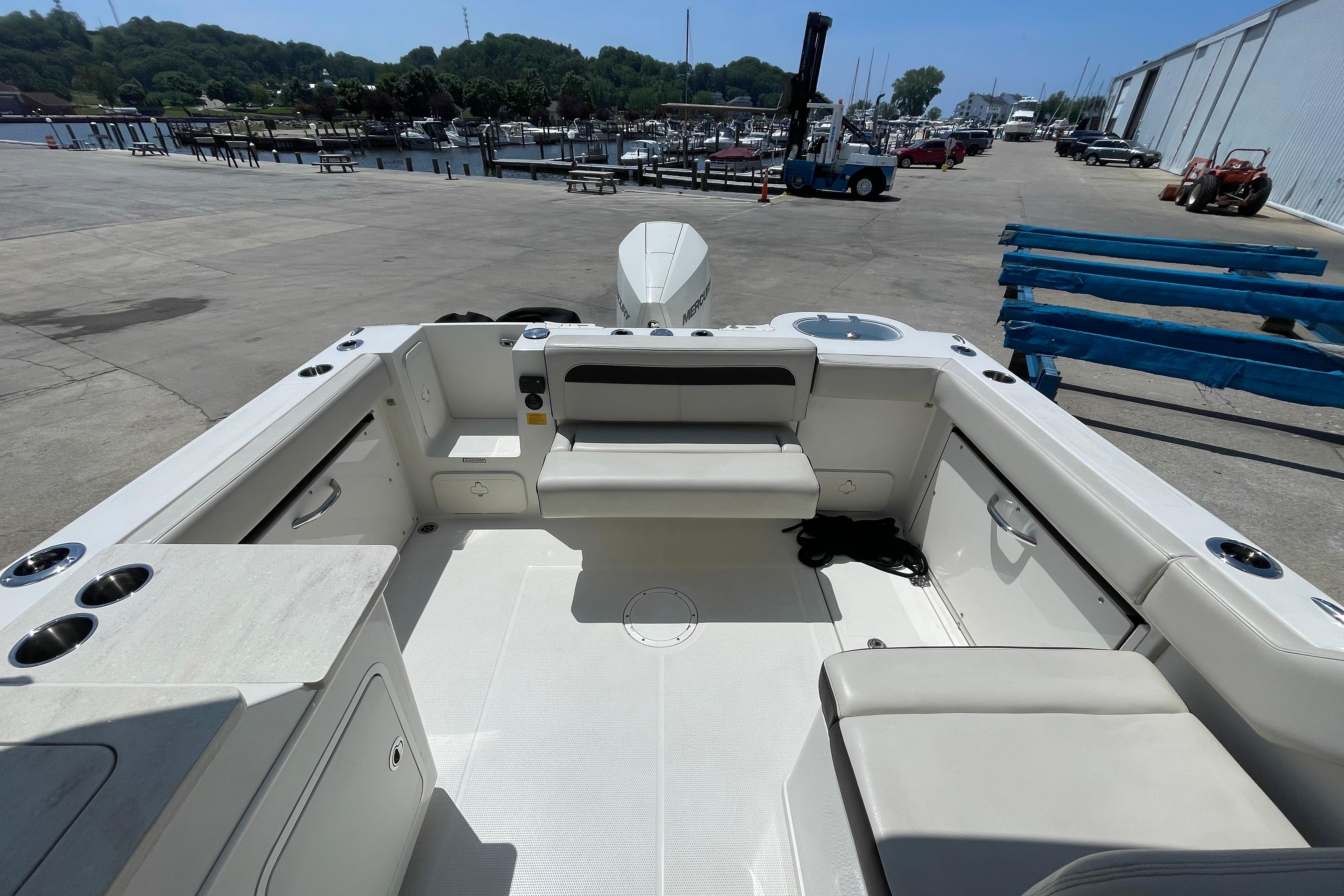 2022 Sailfish 245 DC boat interior with seating and storage, dockside view.