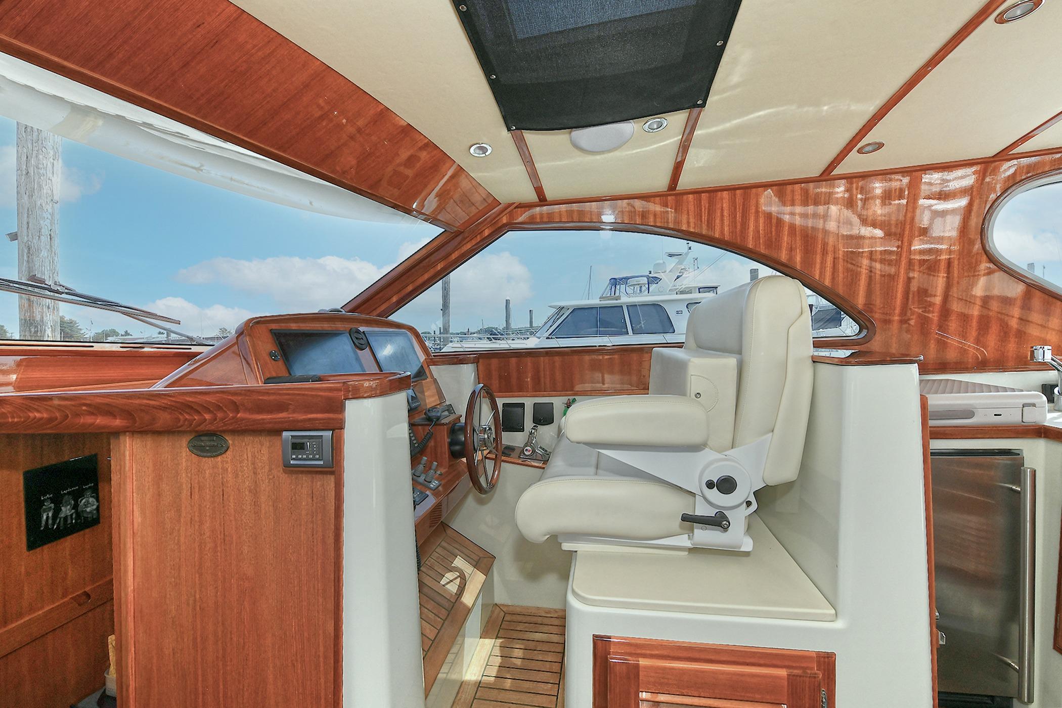 Luxurious 2005 San Juan Downeast Express yacht interior with elegant wood finish and plush seating.