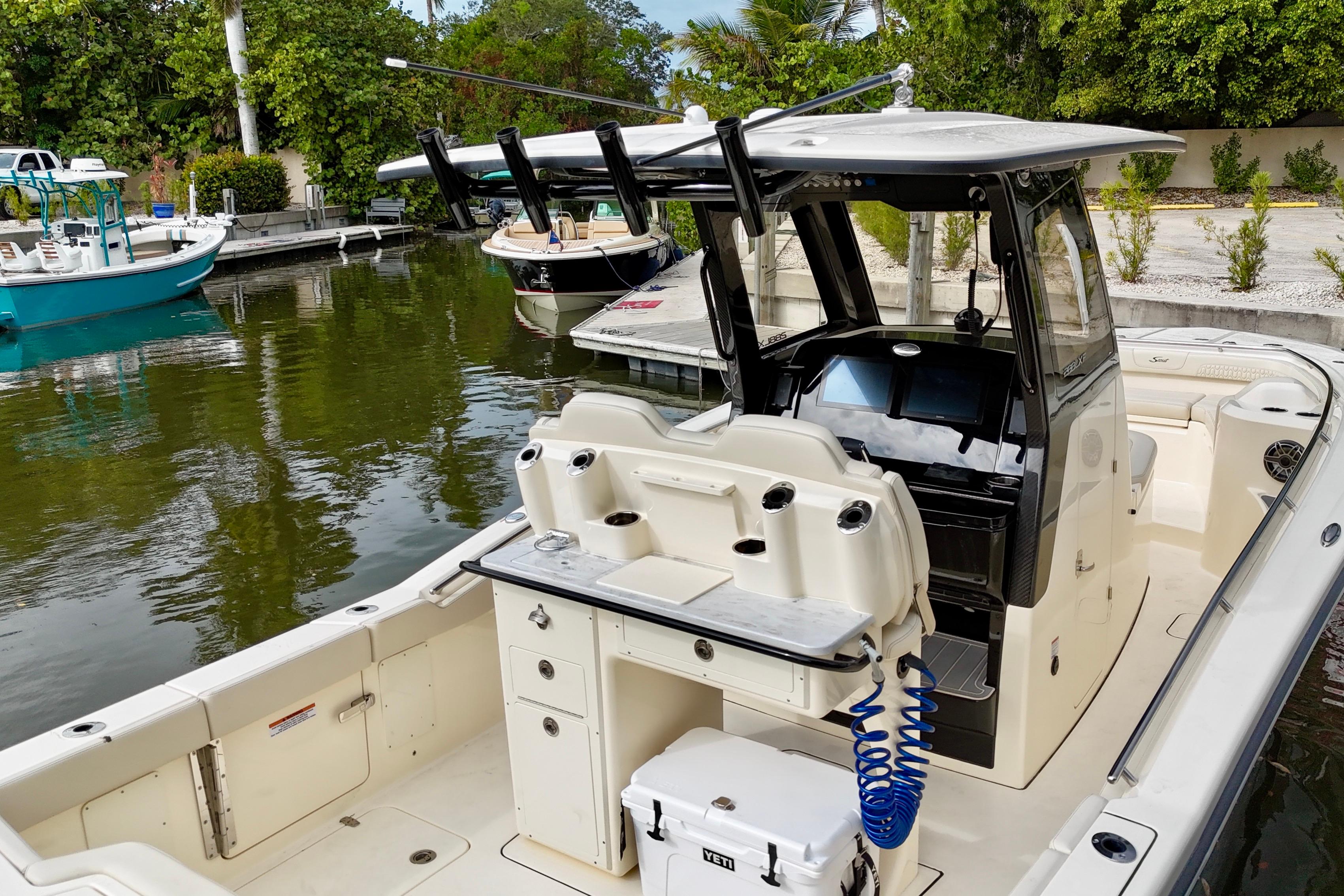2026 Scout 288 LXF boat docked, featuring a sleek design and modern amenities.