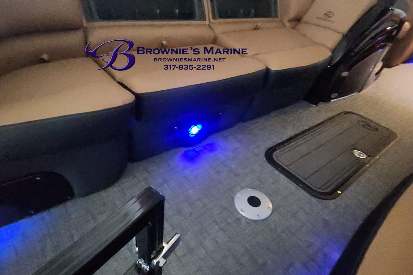 Interior of a 2026 Regency 250 DL boat with seating and blue LED lighting.