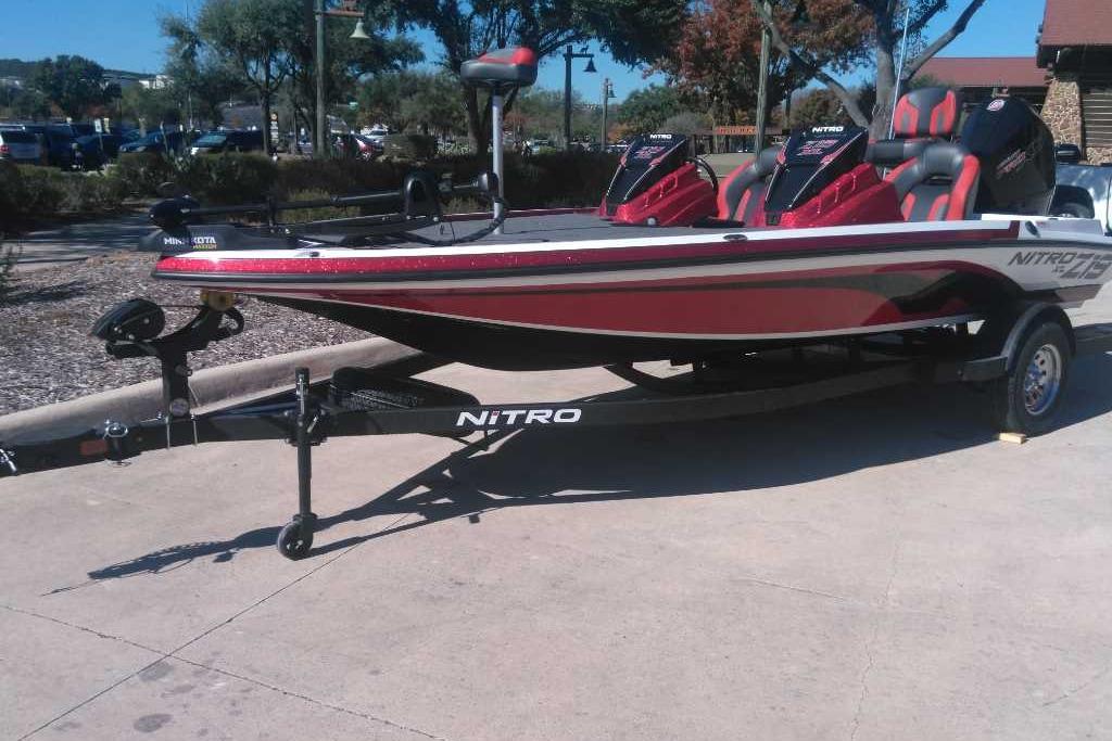 2026 Nitro Z19 XL boat on trailer, red and black design, parked outdoors.