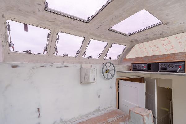 Interior of 2025 Catamaran Bloomfield 86 Motorsailor with skylights and control panel.