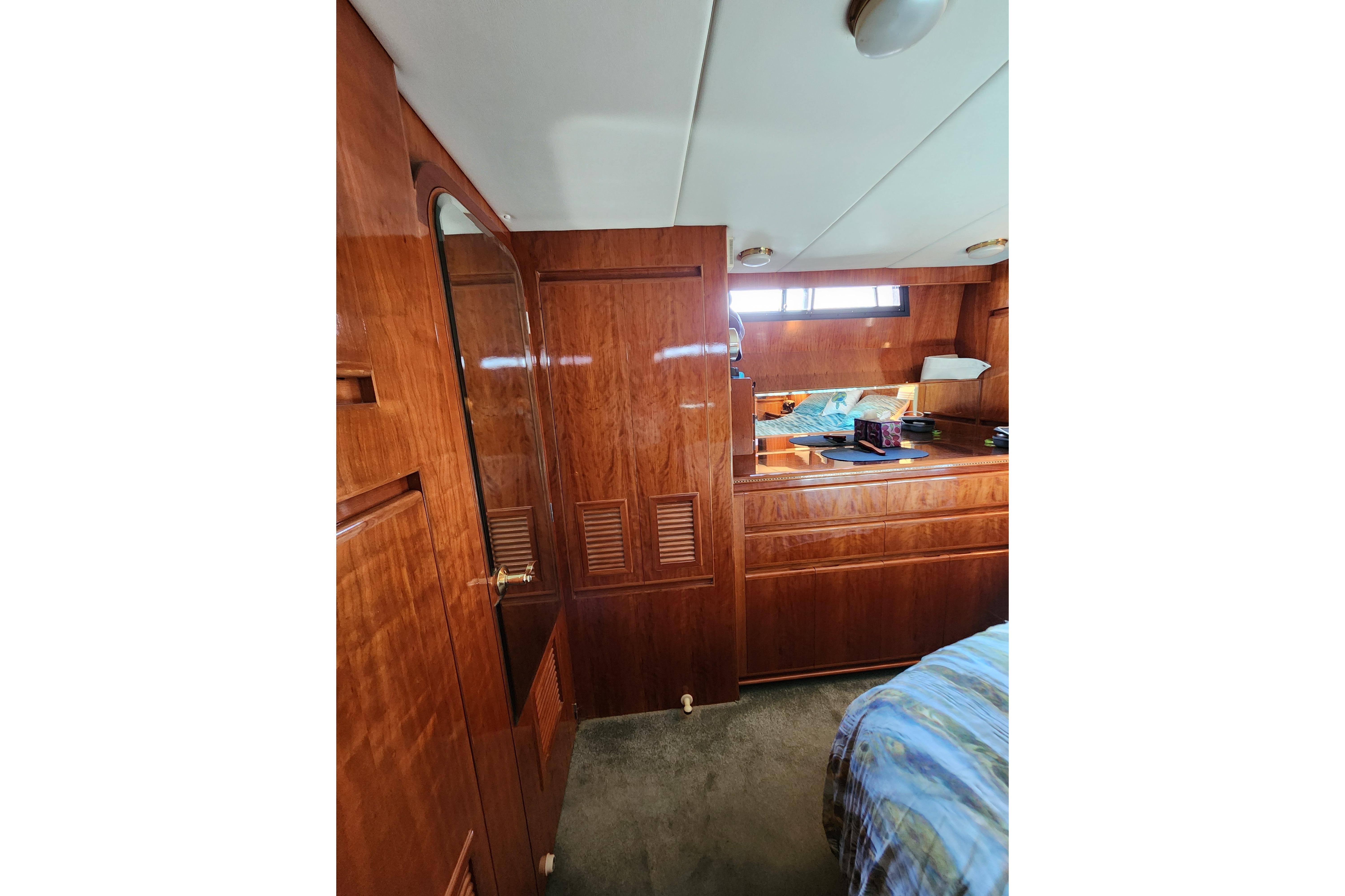 Interior of 2000 Novatec Cockpit Motor Yacht with wooden cabinetry and cozy furnishings.