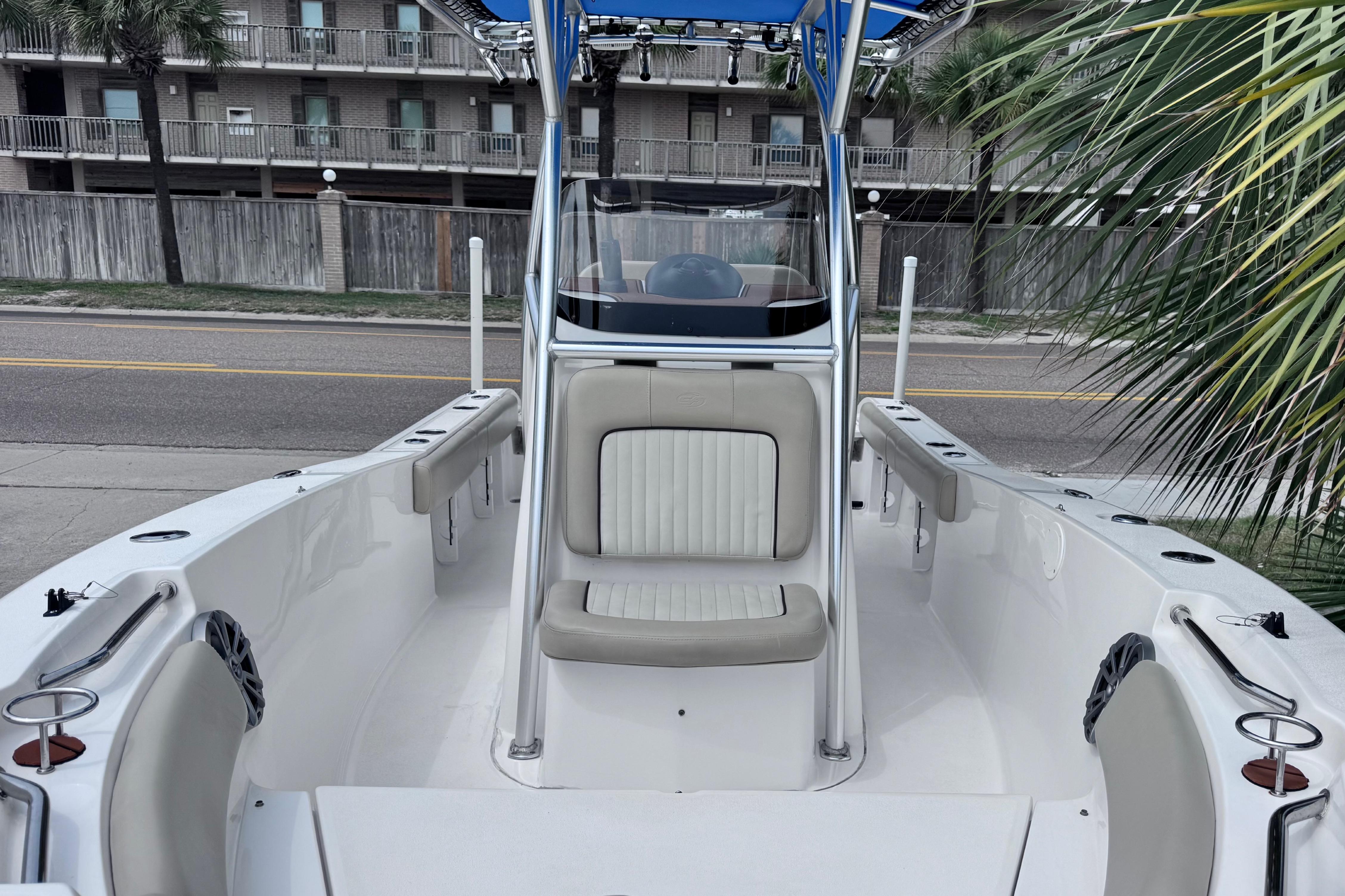 2018 Sea Fox 206 Commander boat interior with seating, docked near a street and palm trees.