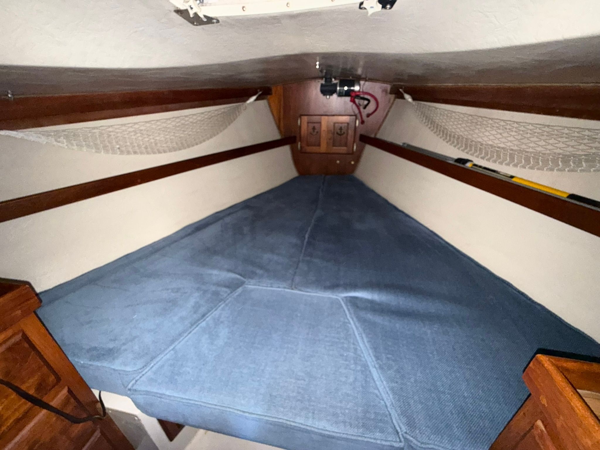 Interior of a 1980 Catalina 38 sailboat with blue upholstery.