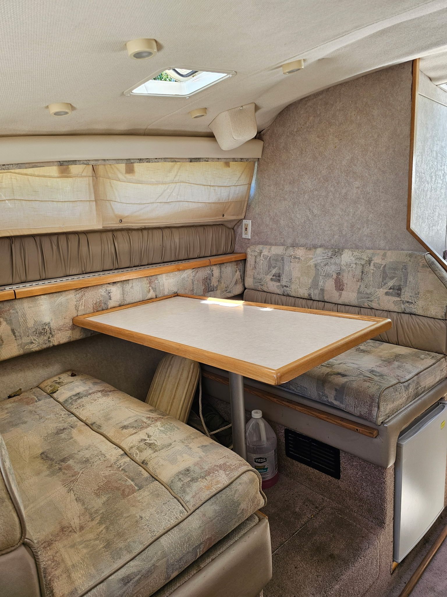 Interior of the 1998 Bayliner 2855 Ciera Sunbridge with seating area and table.
