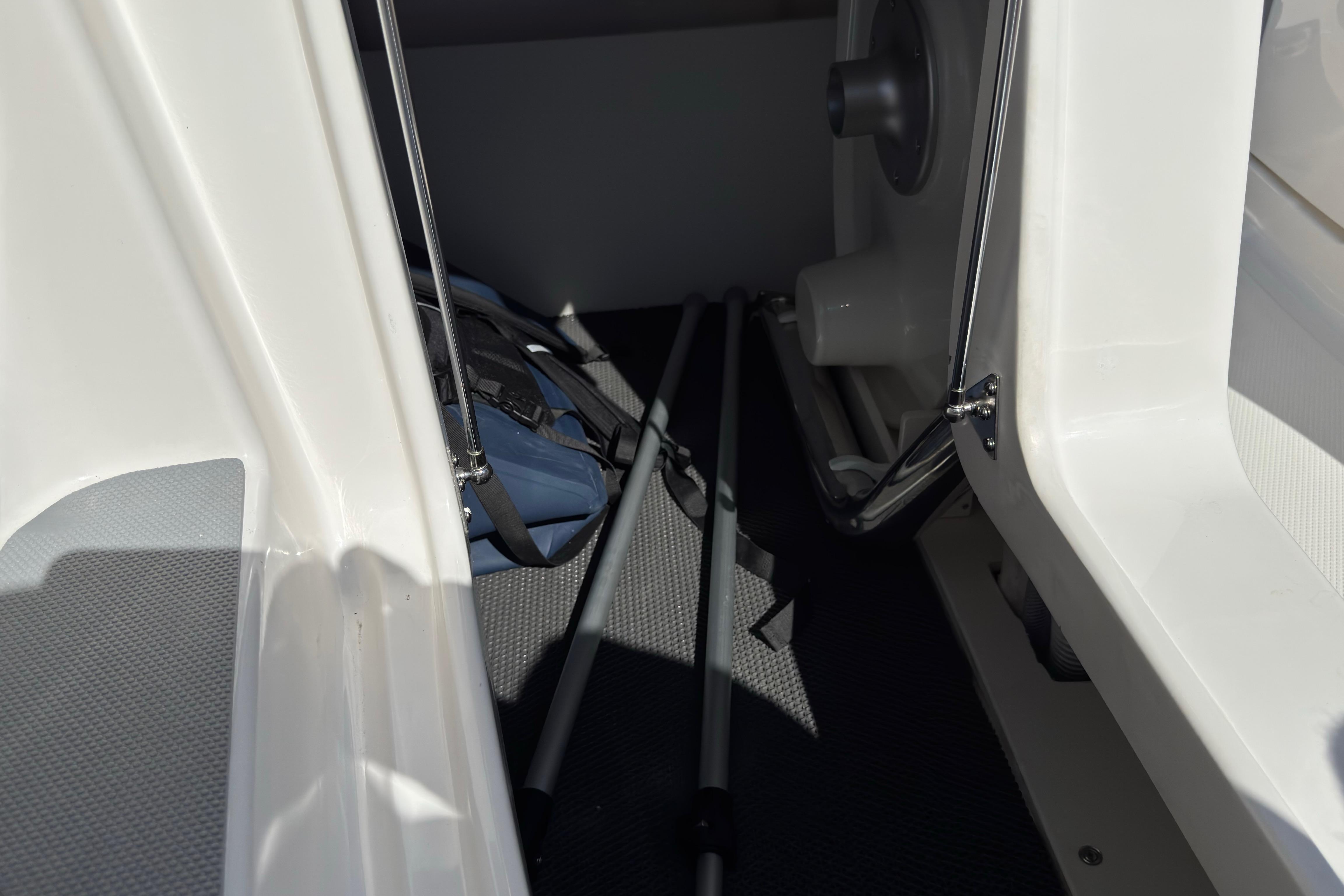 Interior view of 2026 Chaparral SSX 4 boat storage area with equipment.