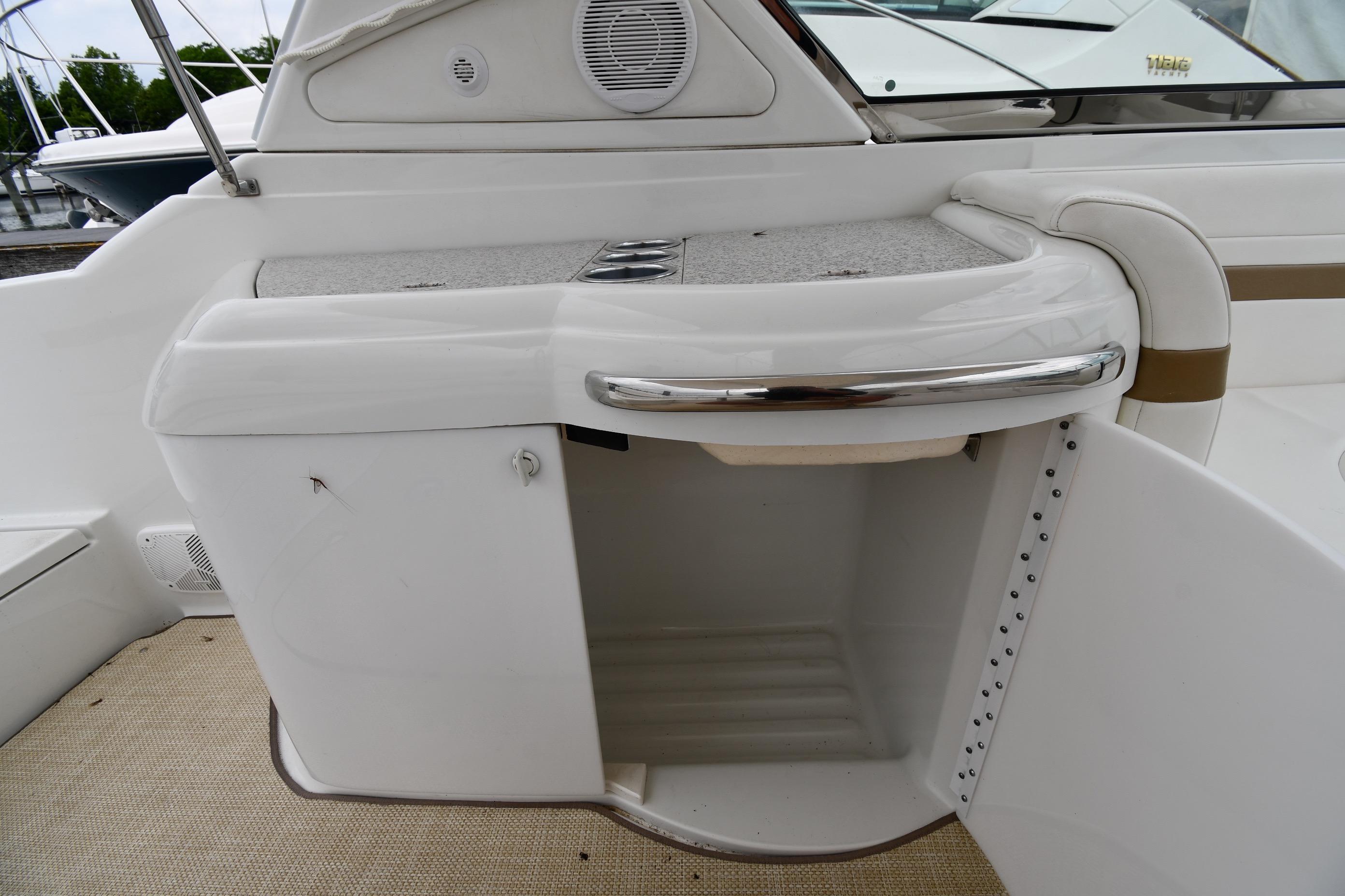 2004 Formula 330 Sun Sport boat interior storage compartment with open door.