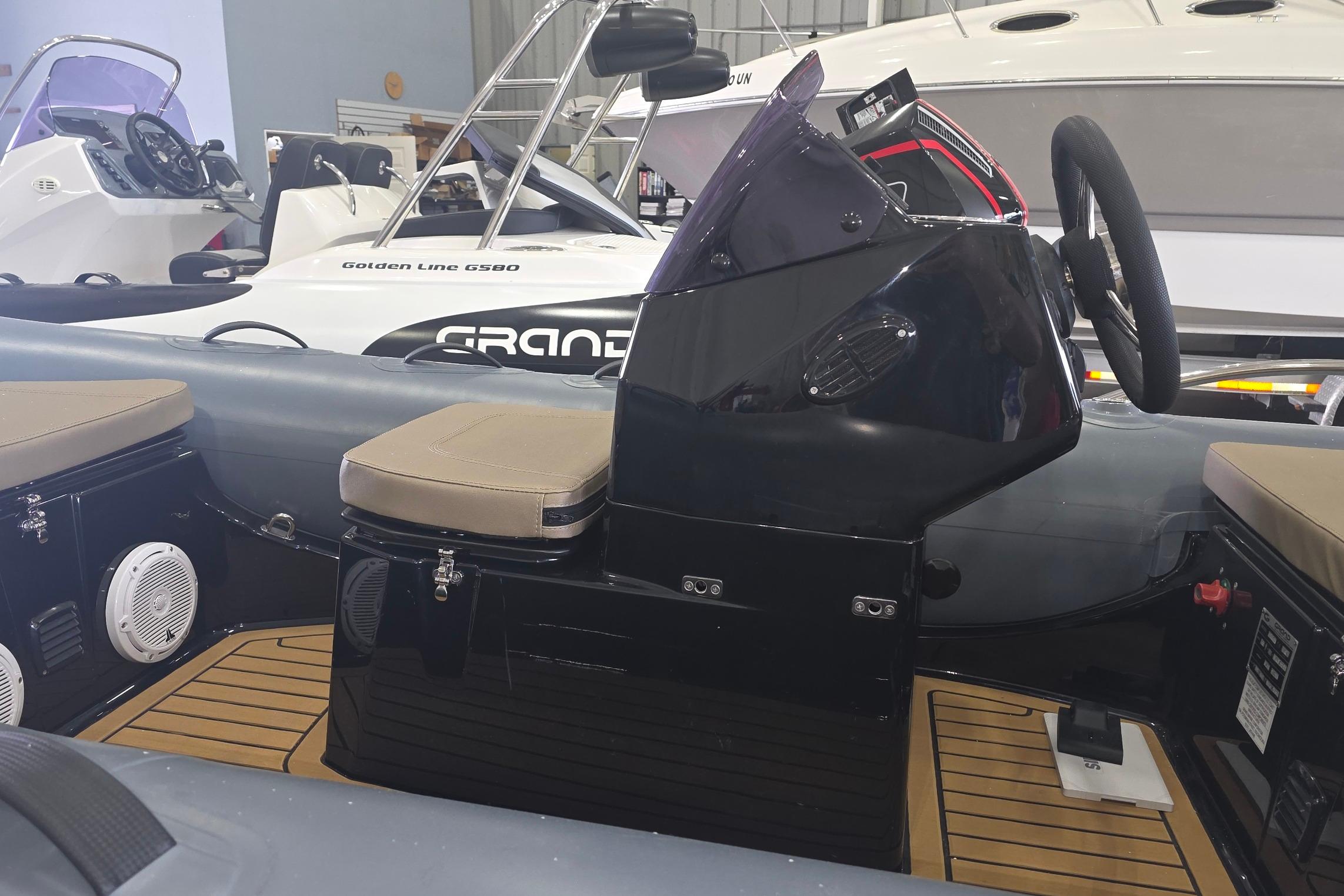 2027 Grand Inflatables G380N boat interior with steering console and seating.